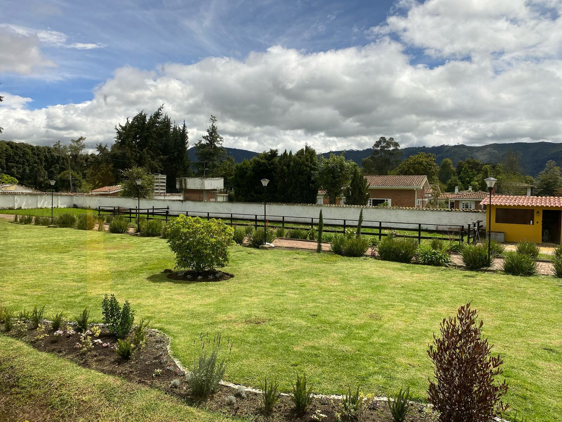 woman wearing yellow long-sleeved dress under white clouds and blue sky during daytime