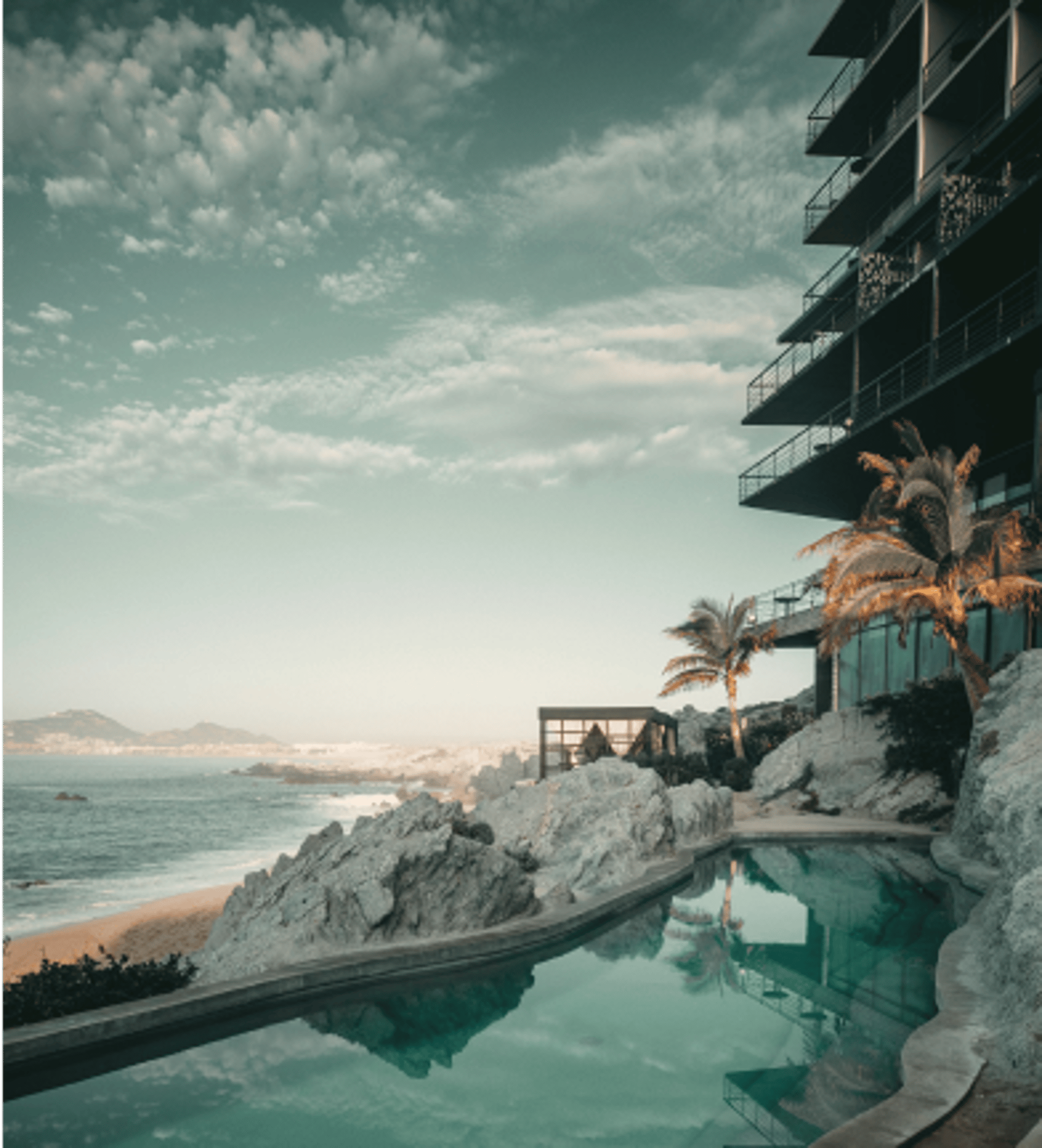 an abstract photo of a curved building with a blue sky in the background