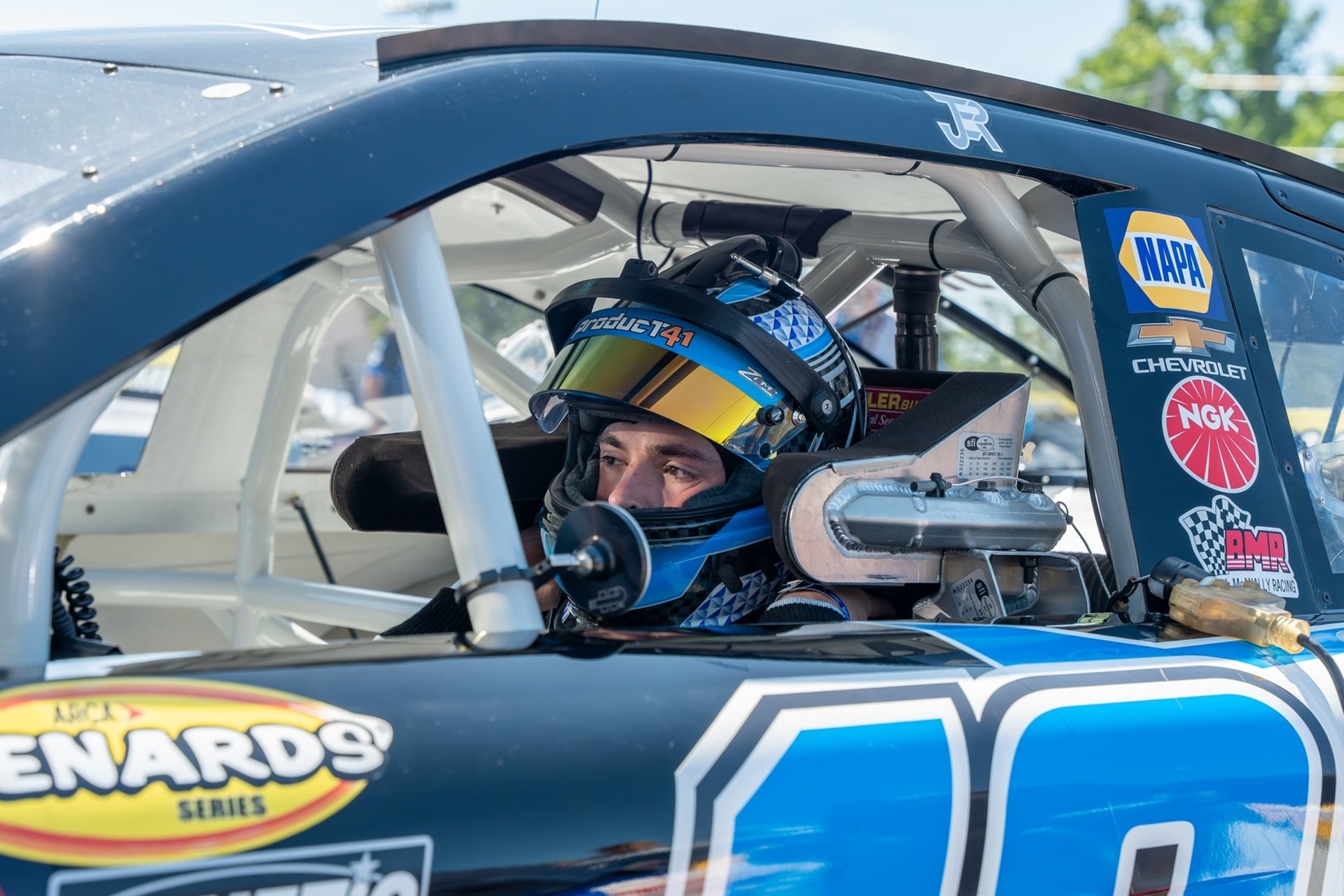 an abstract photo of a curved building with a blue sky in the background