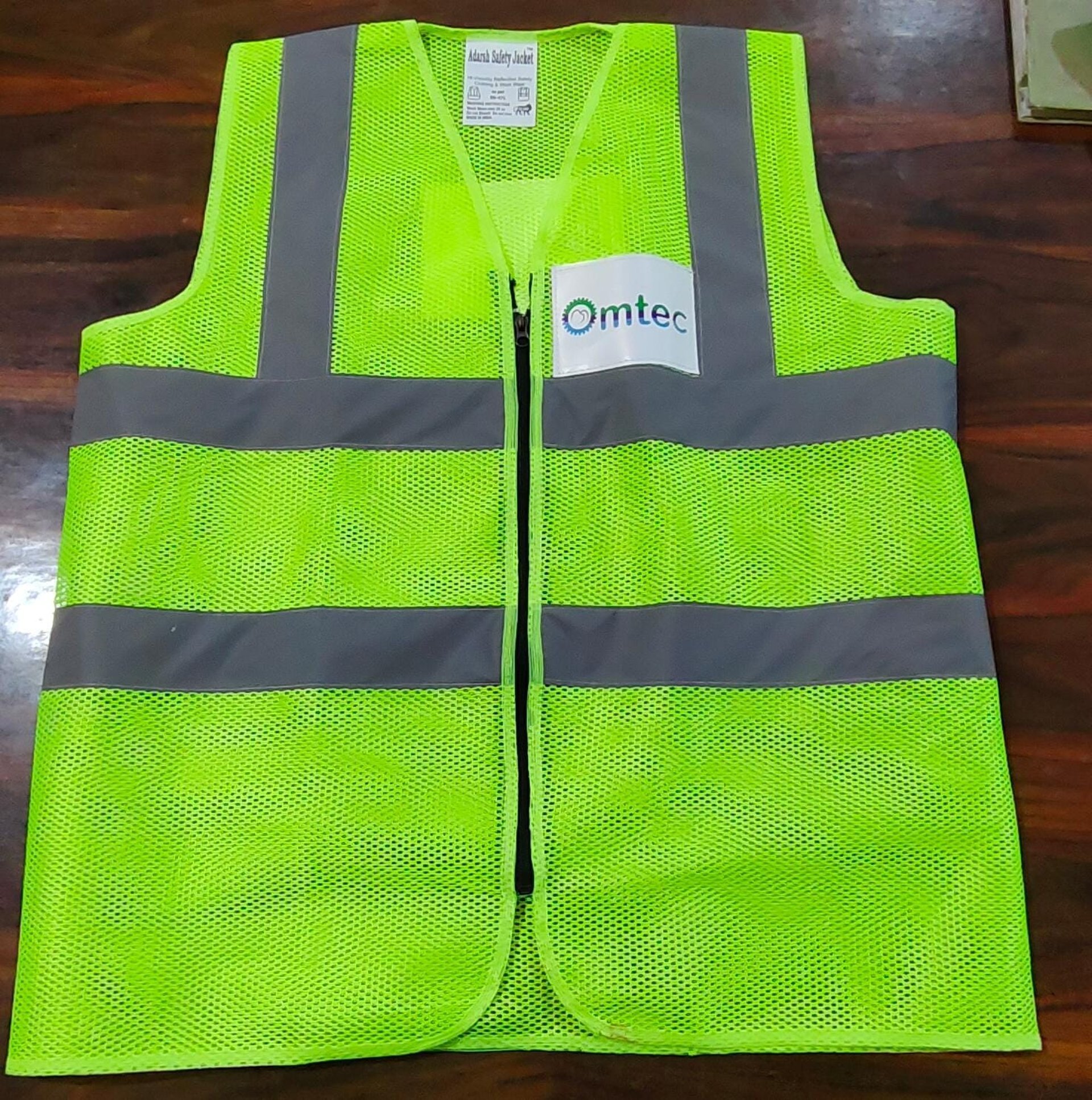 a man in a safety vest standing on a boat