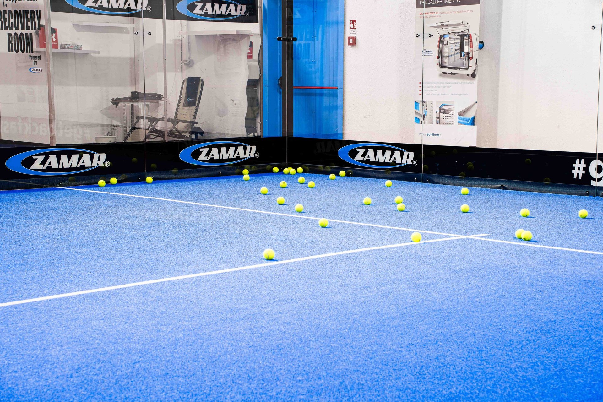 a tennis ball on a tennis court with mountains in the background