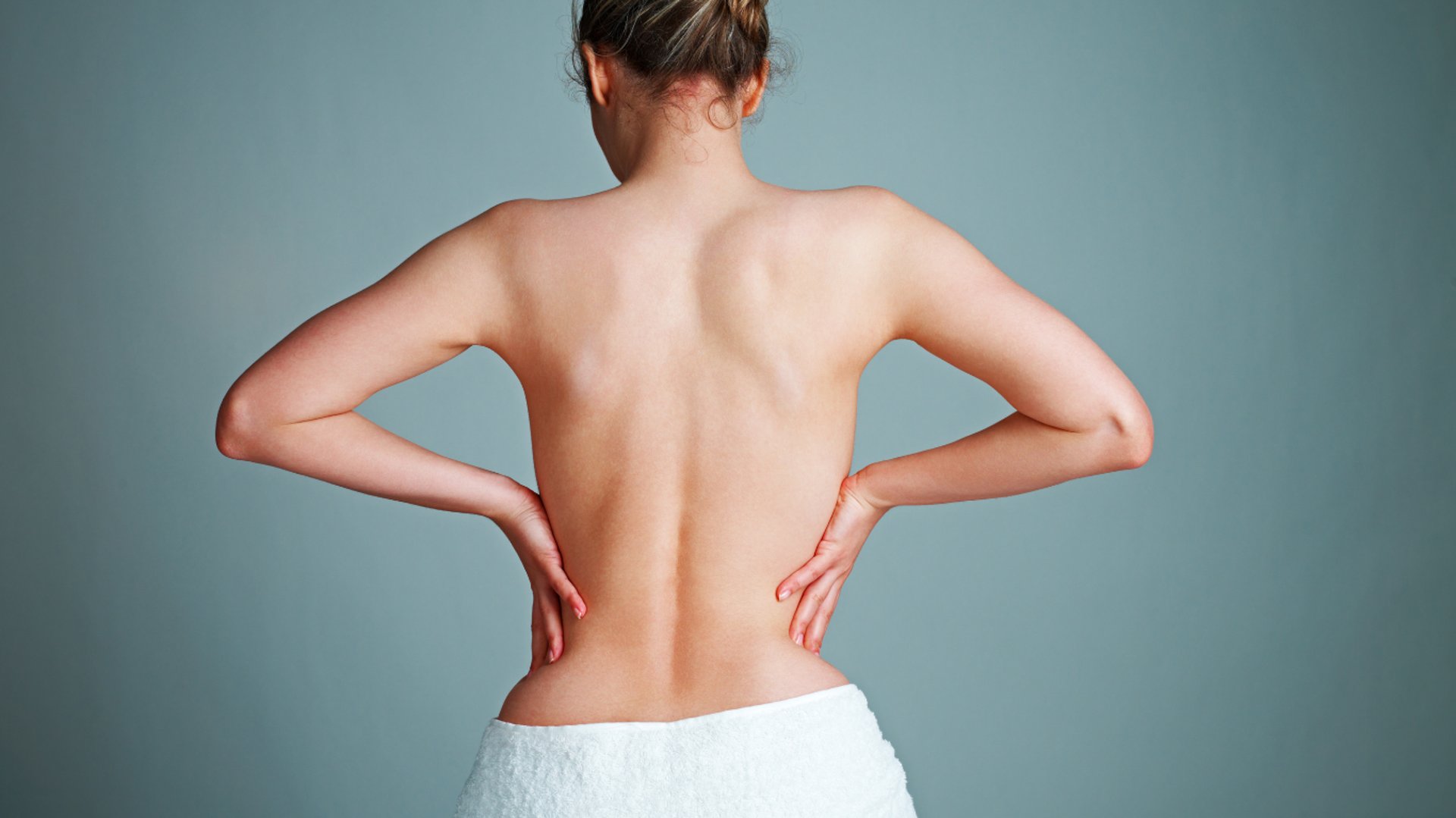 a person holding another person's hand in a hospital bed