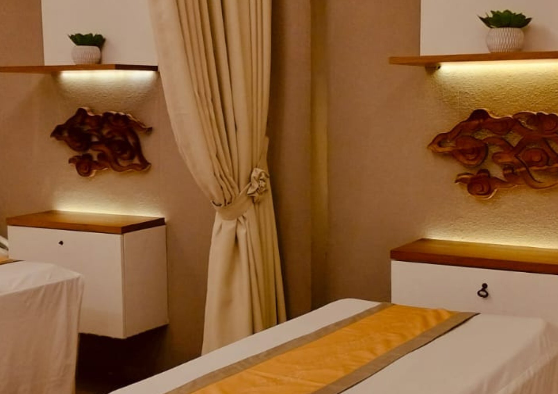 a person holding another person's hand in a hospital bed