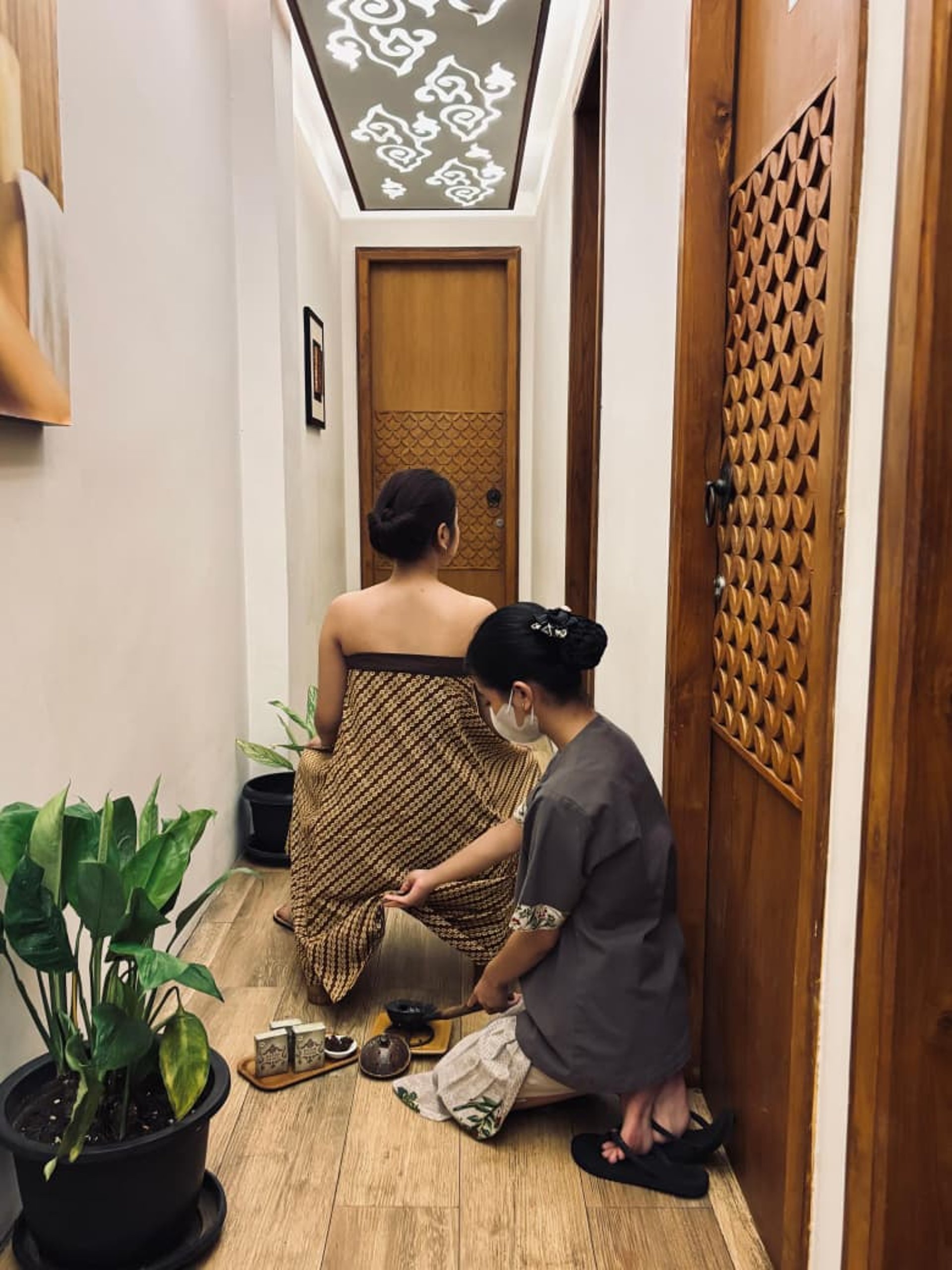 a person holding another person's hand in a hospital bed