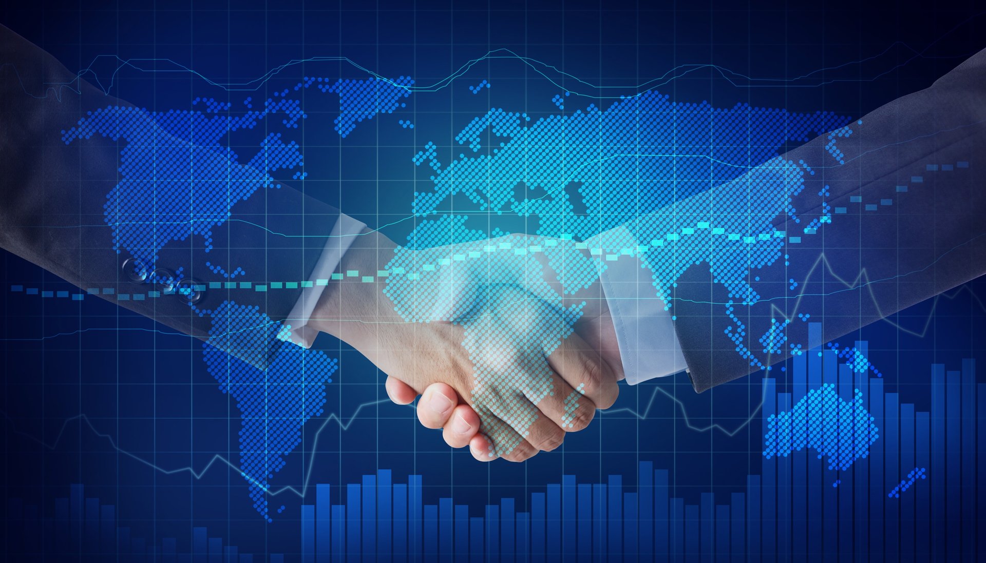 two people shaking hands in front of a computer monitor