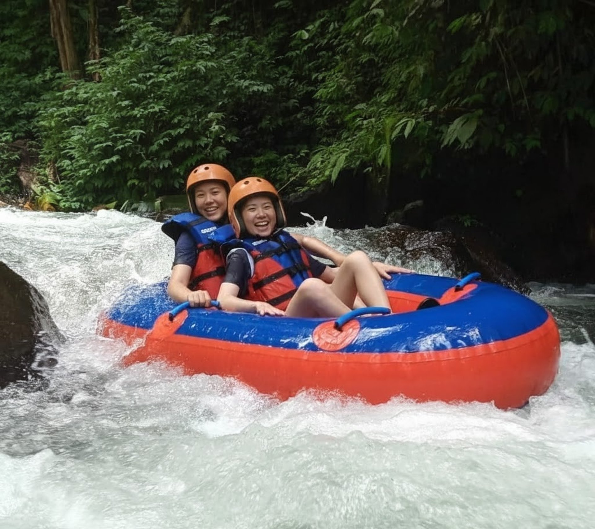 2 men riding blue kayak on green grass during daytime
