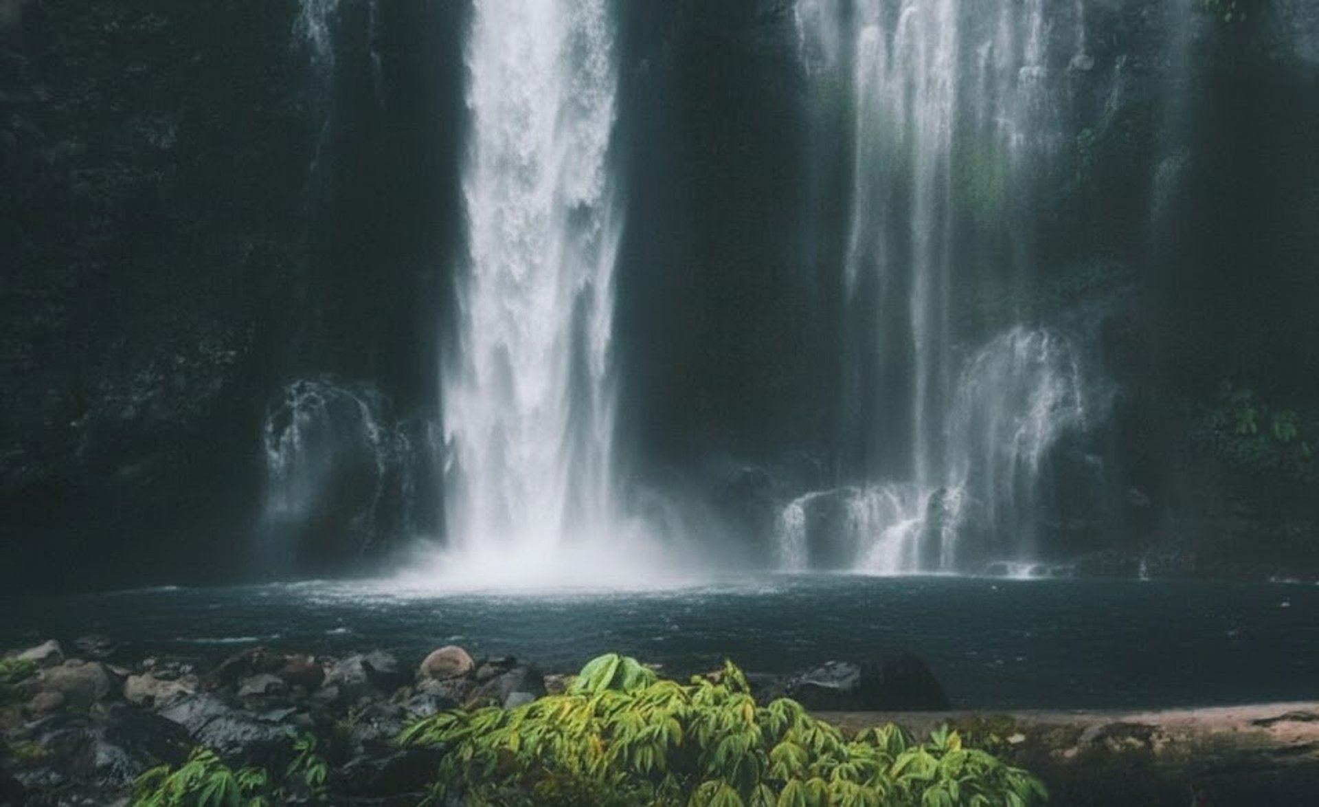 man squatting on mountain top during daytime