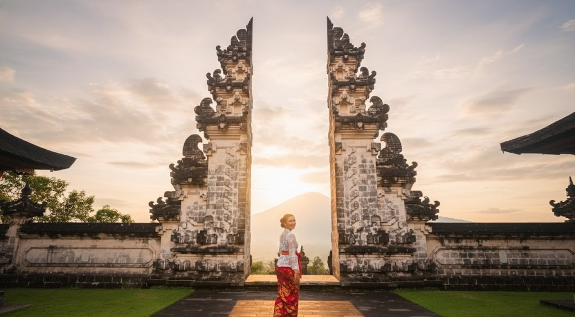 man squatting on mountain top during daytime