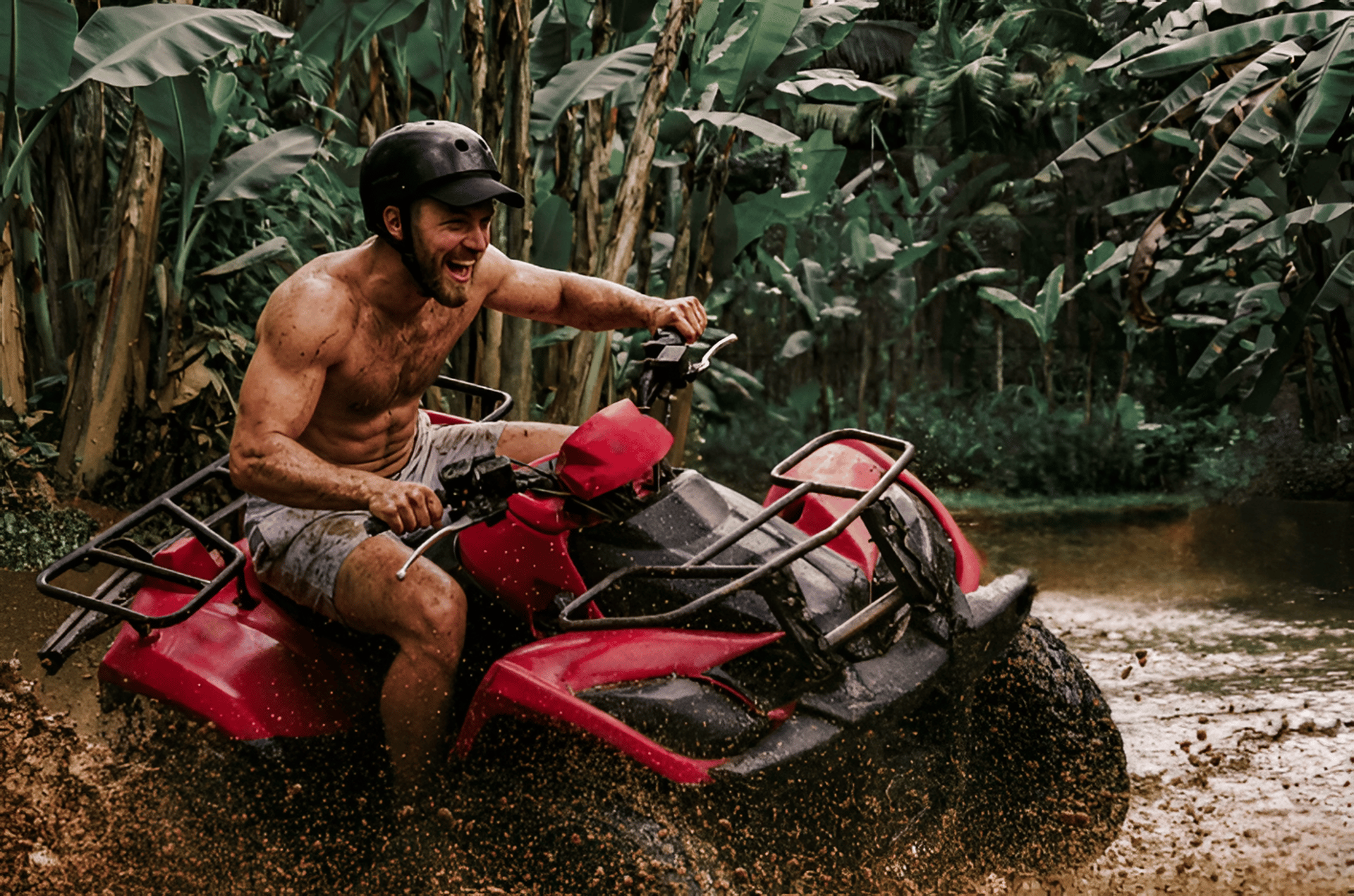 man riding red atv on brown field during daytime