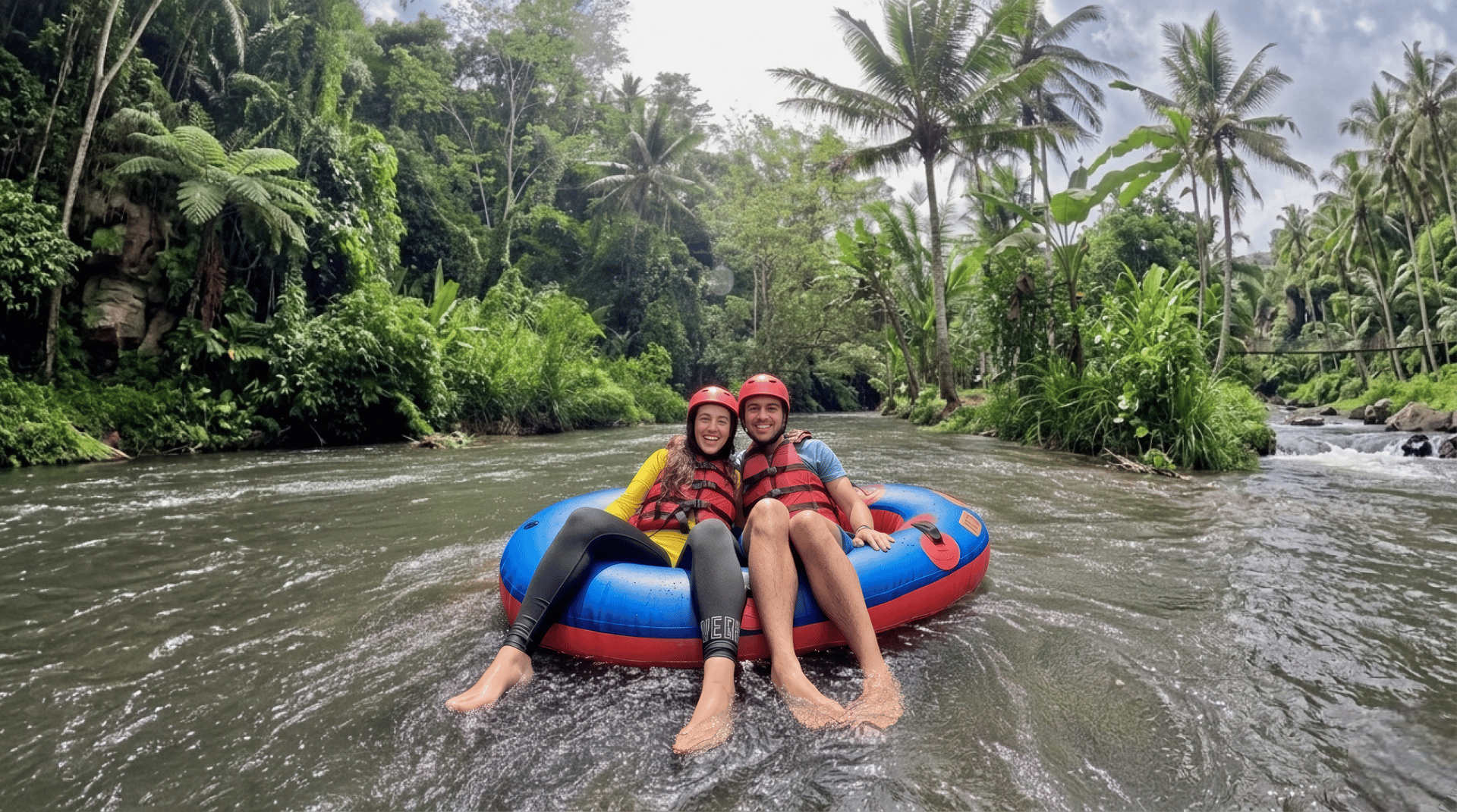 2 men riding blue kayak on green grass during daytime