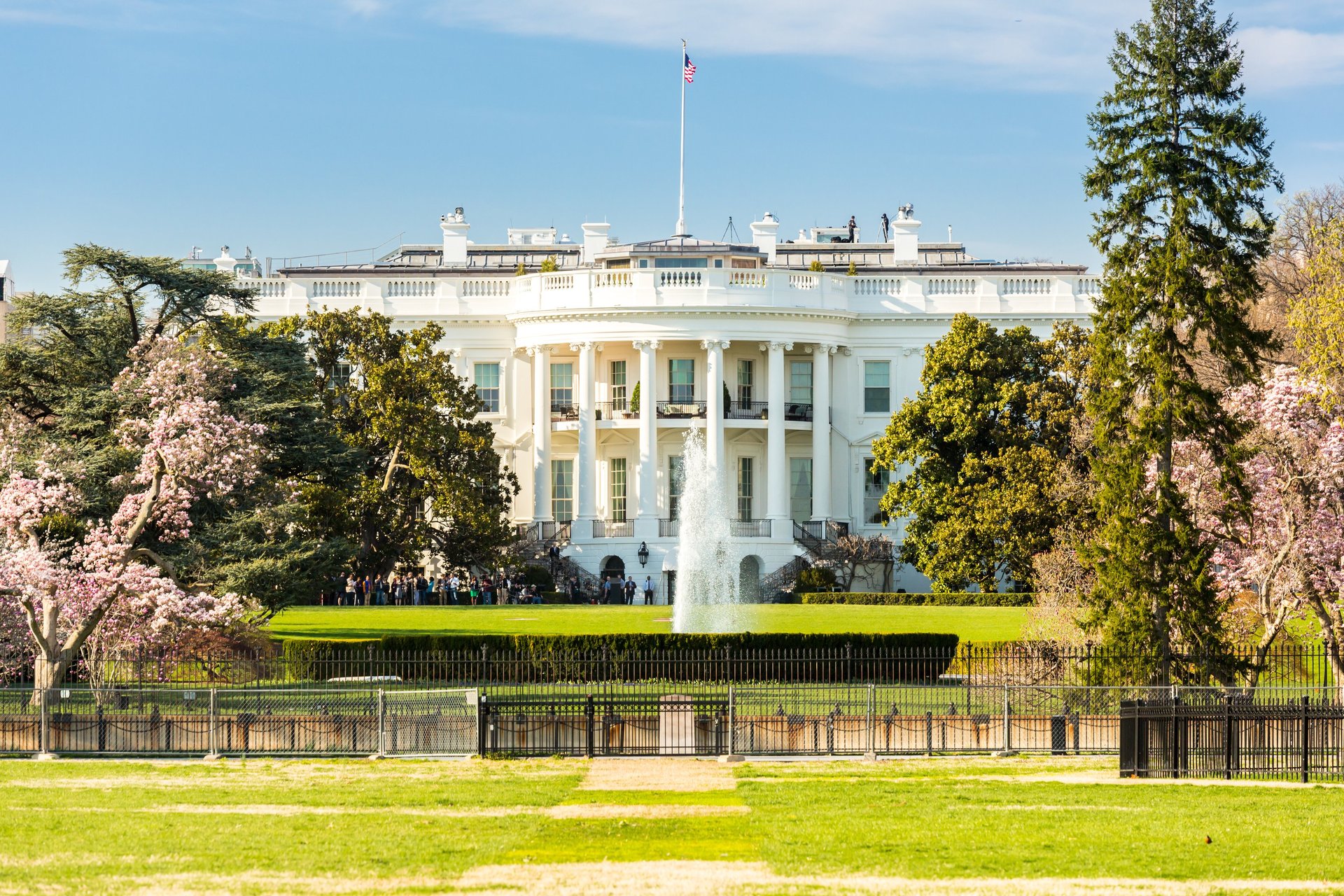 a white house with a flag on top of it