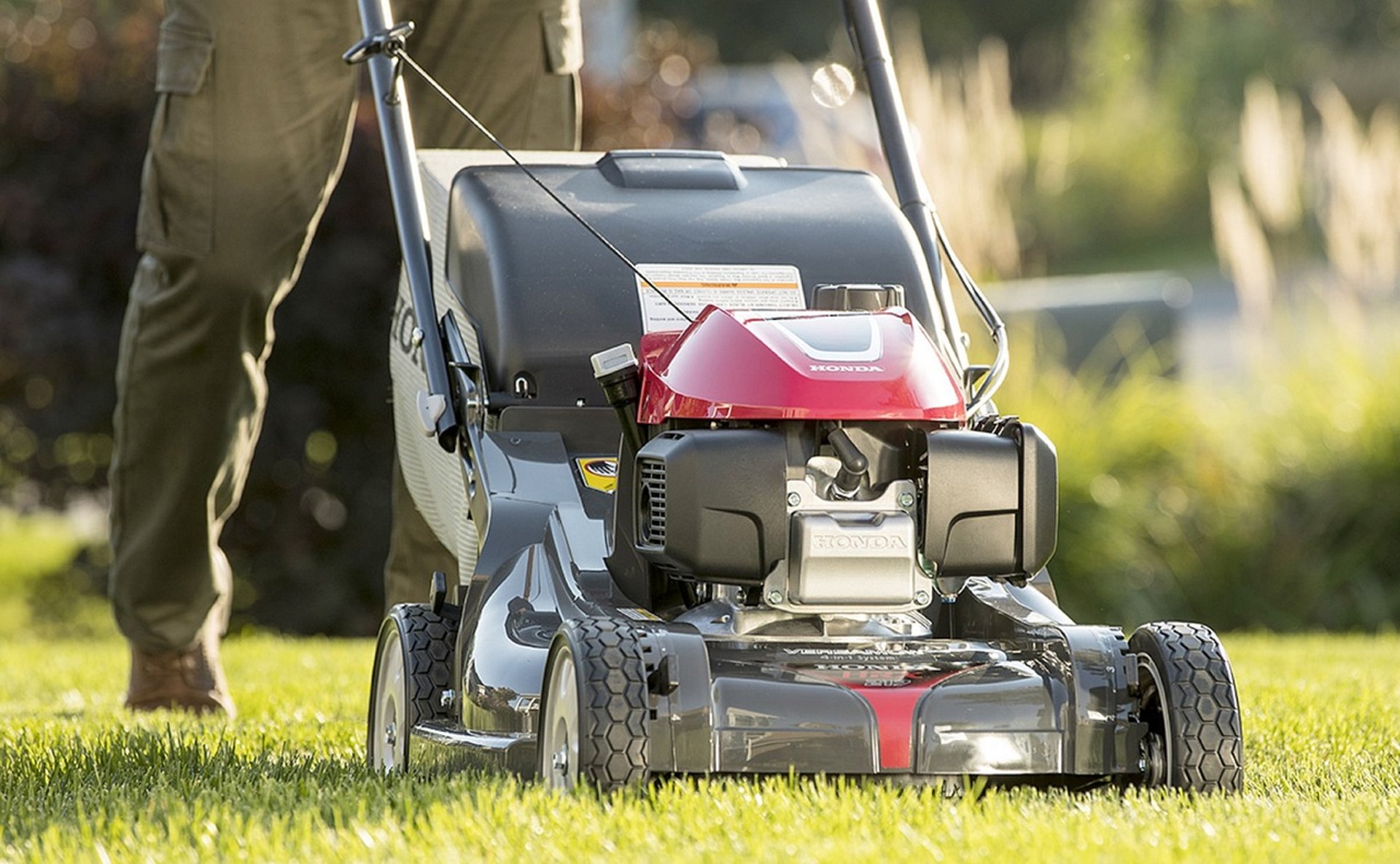 green and black ride on lawn mower on green grass field during daytime