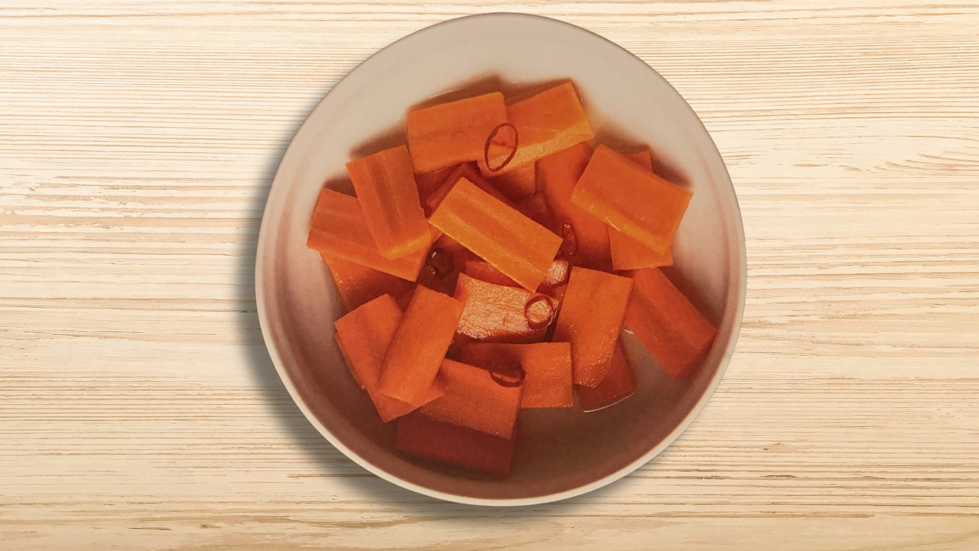 a person eating sushi with chopsticks on a table