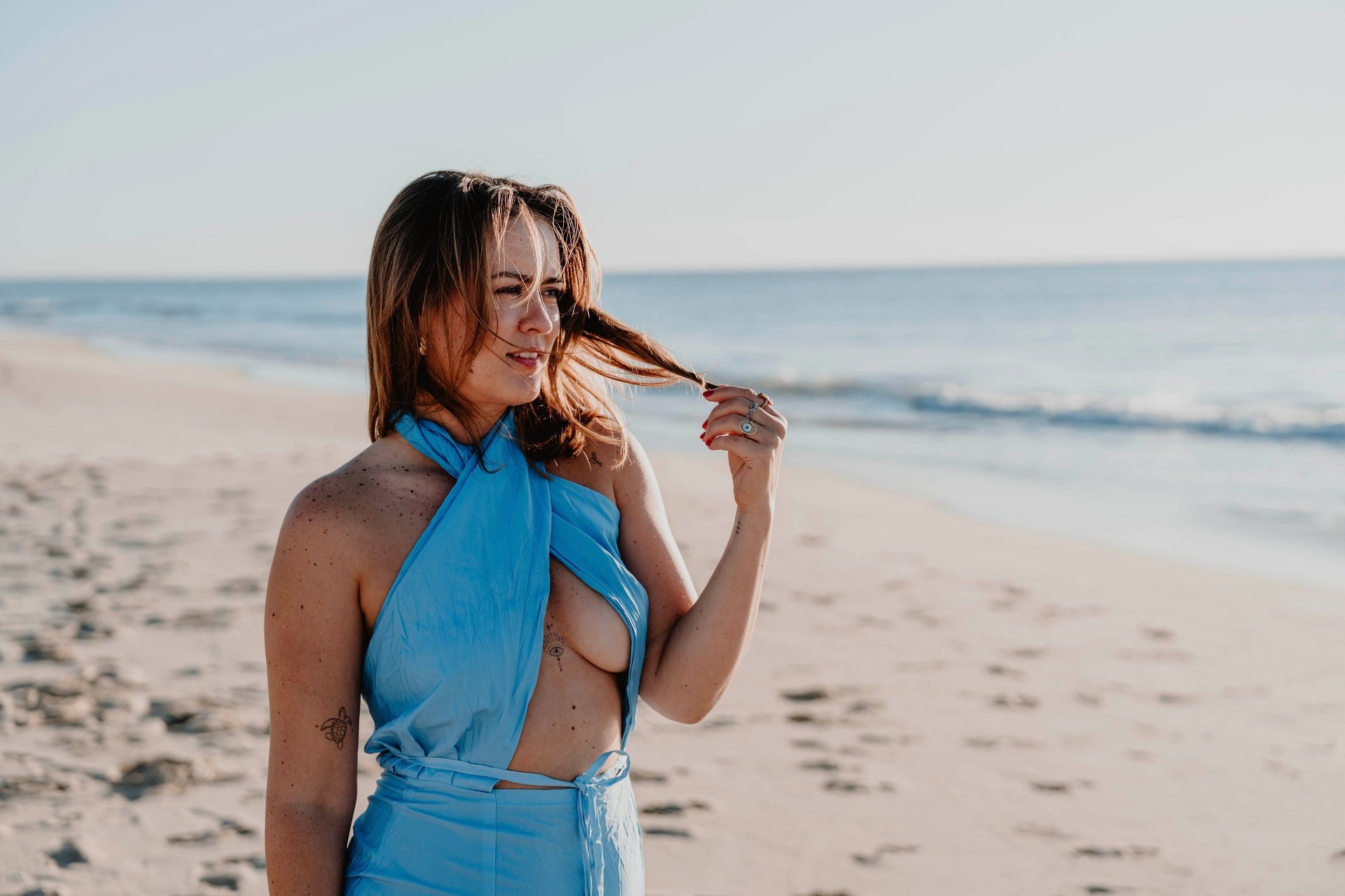 woman in white and brown dress standing on green grass during night time