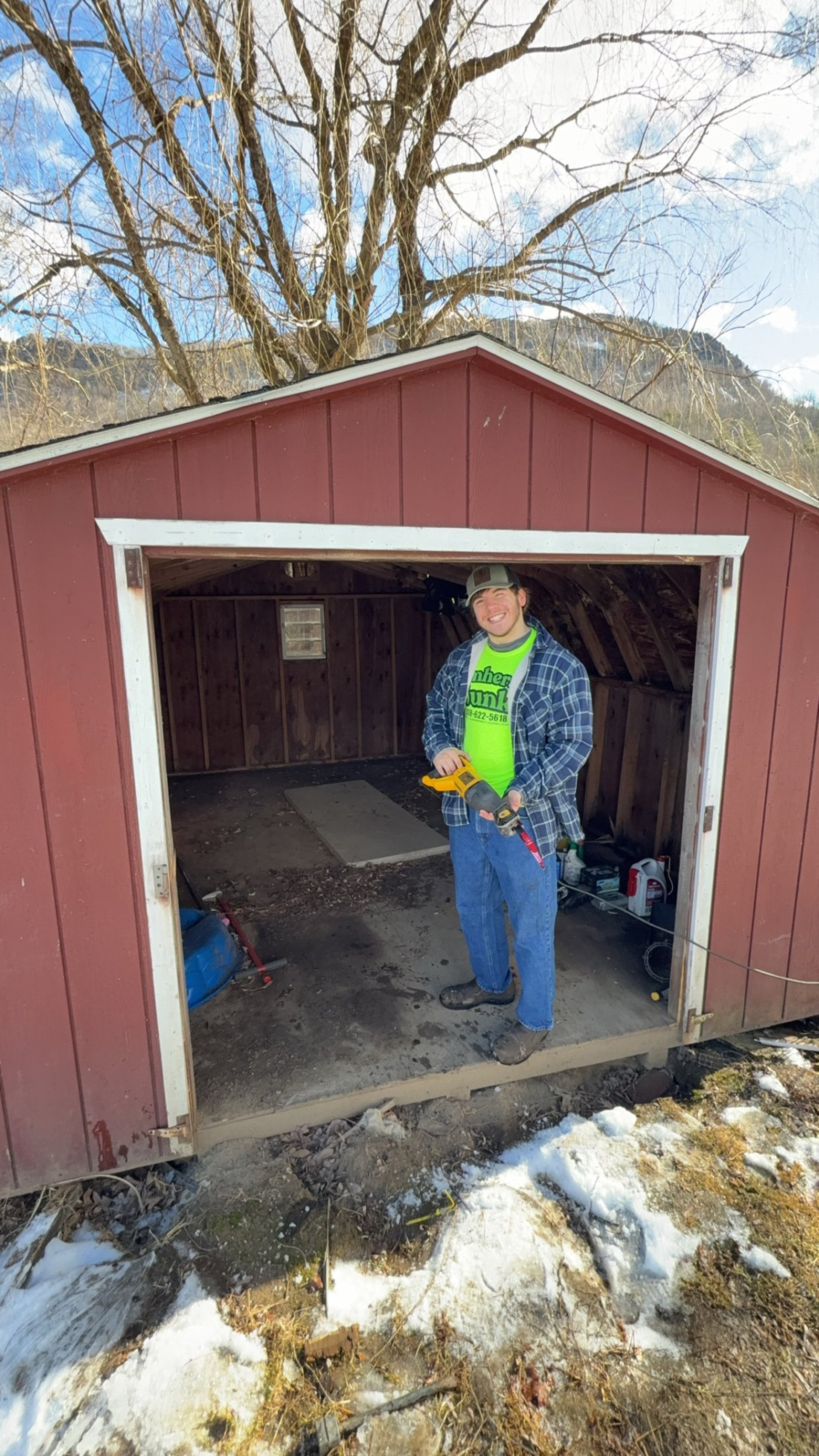 Old dishwasher being removed from kitchen during appliance cleanout