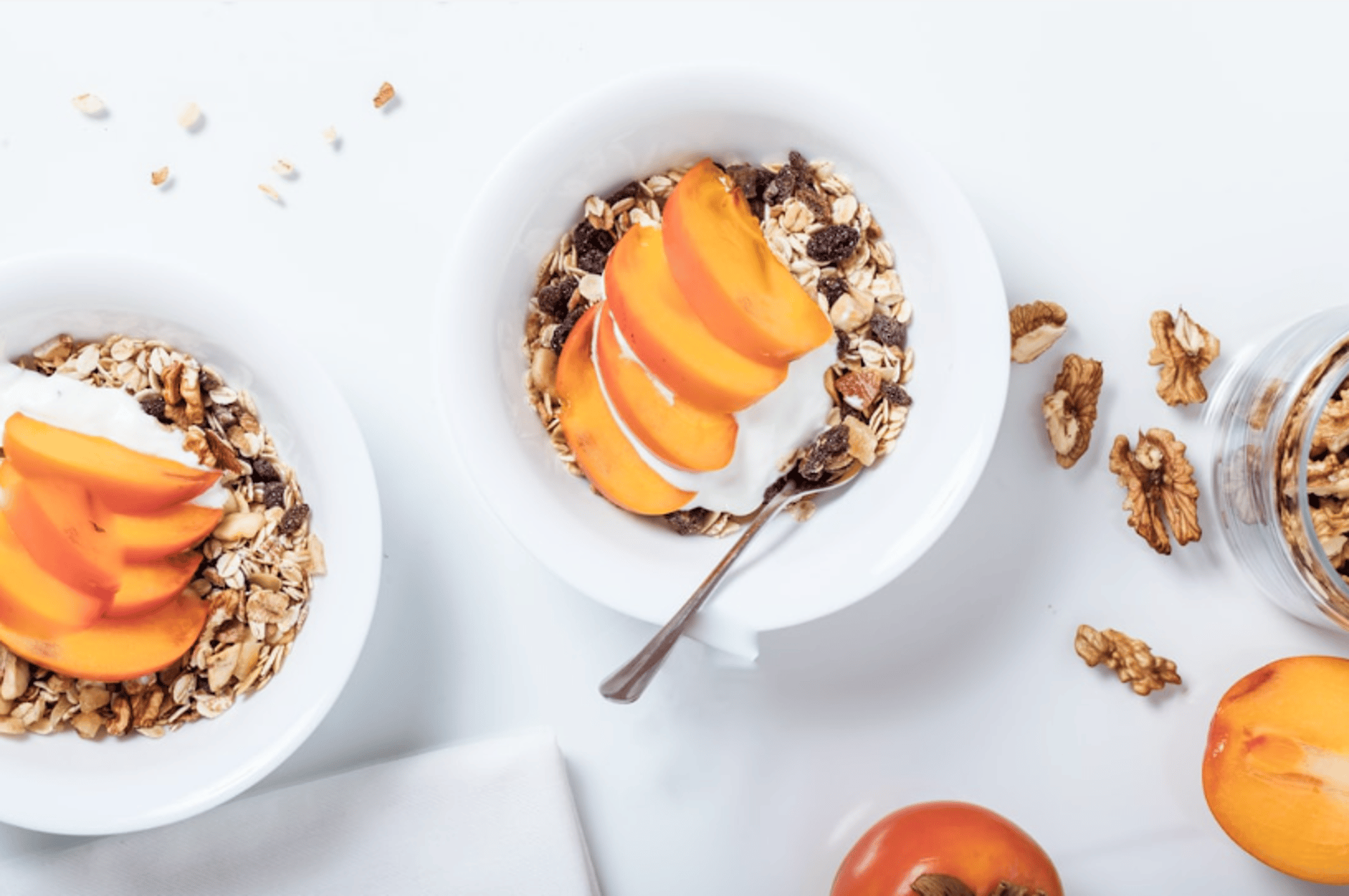 bowl of cereal with sliced fruits and spoon