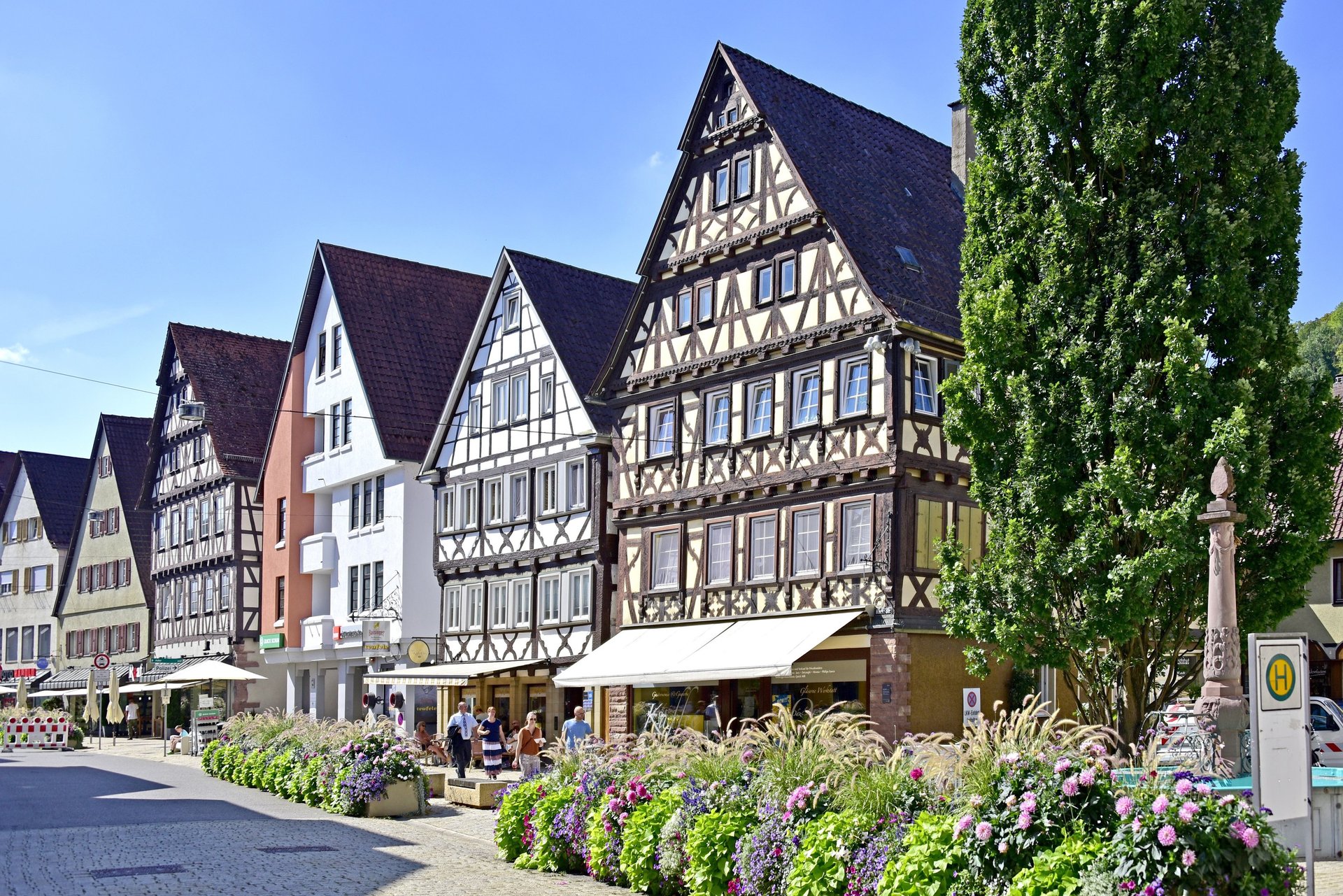 brown and white concrete houses beside river under blue sky during daytime