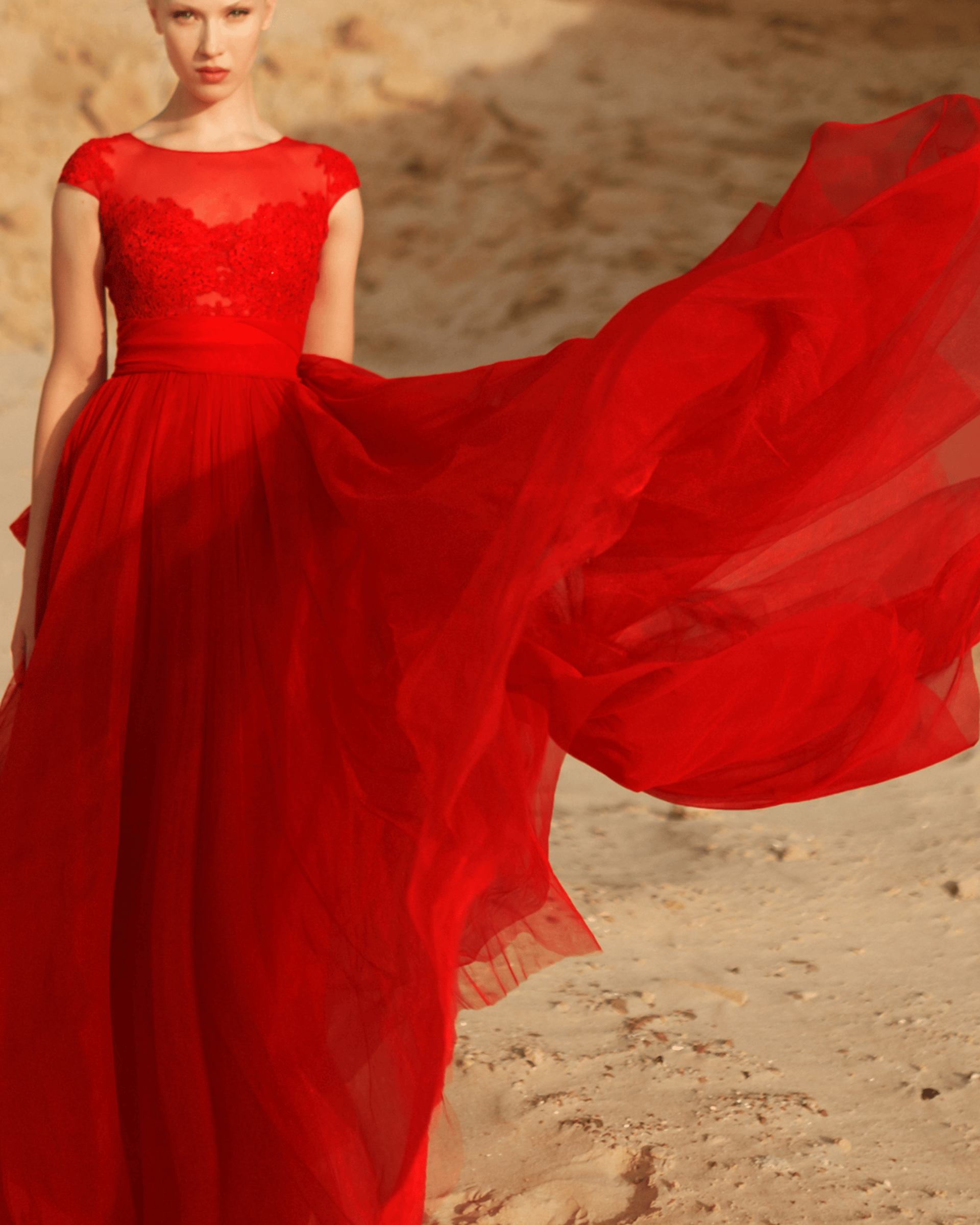 Empowered woman in red flowy dress, symbolizing the Fire Phoenix Archetype, financial and spiritual freedom