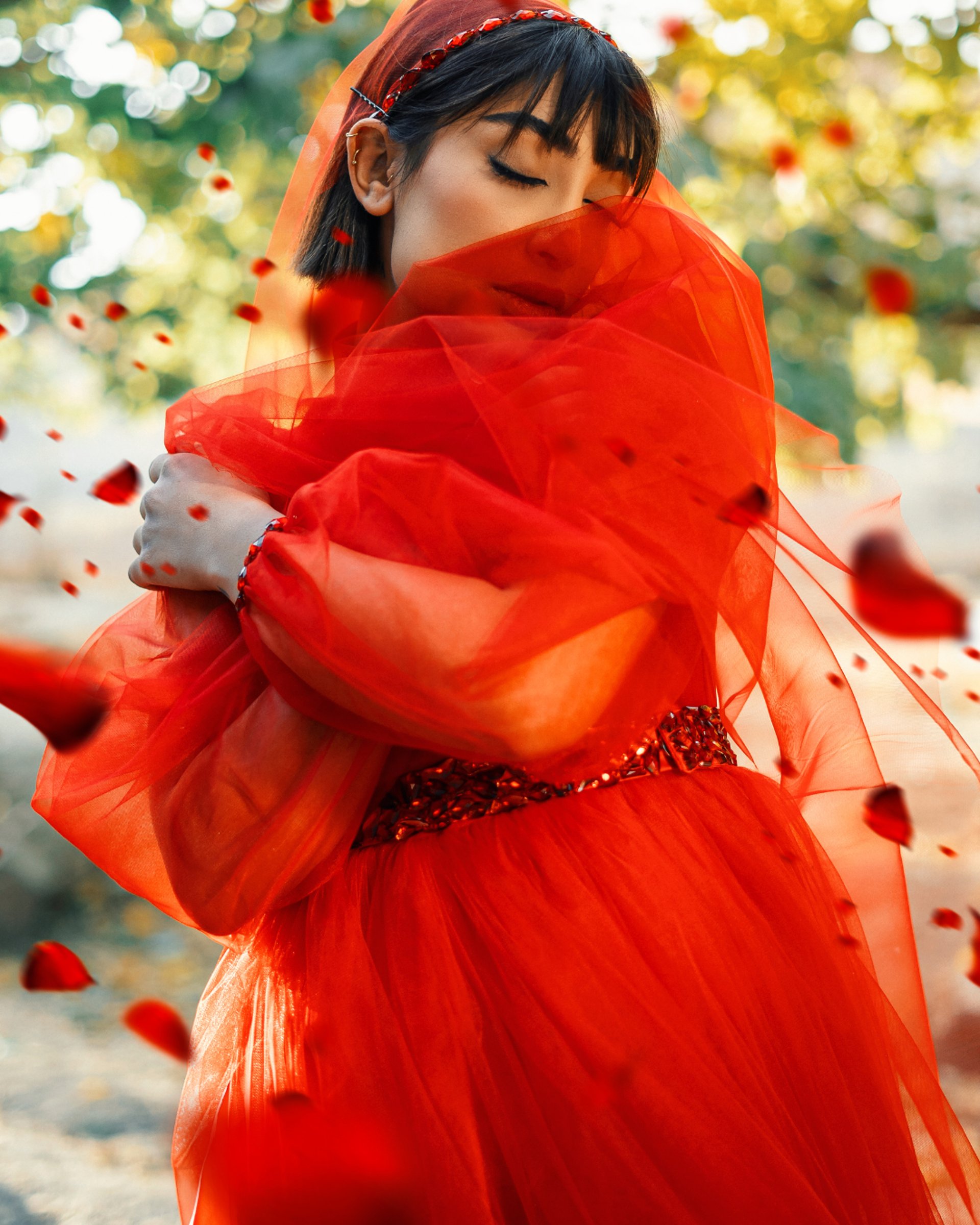 Empowered woman in red flowy dress, symbolizing a Phoenix rising as financial and spiritual freedom