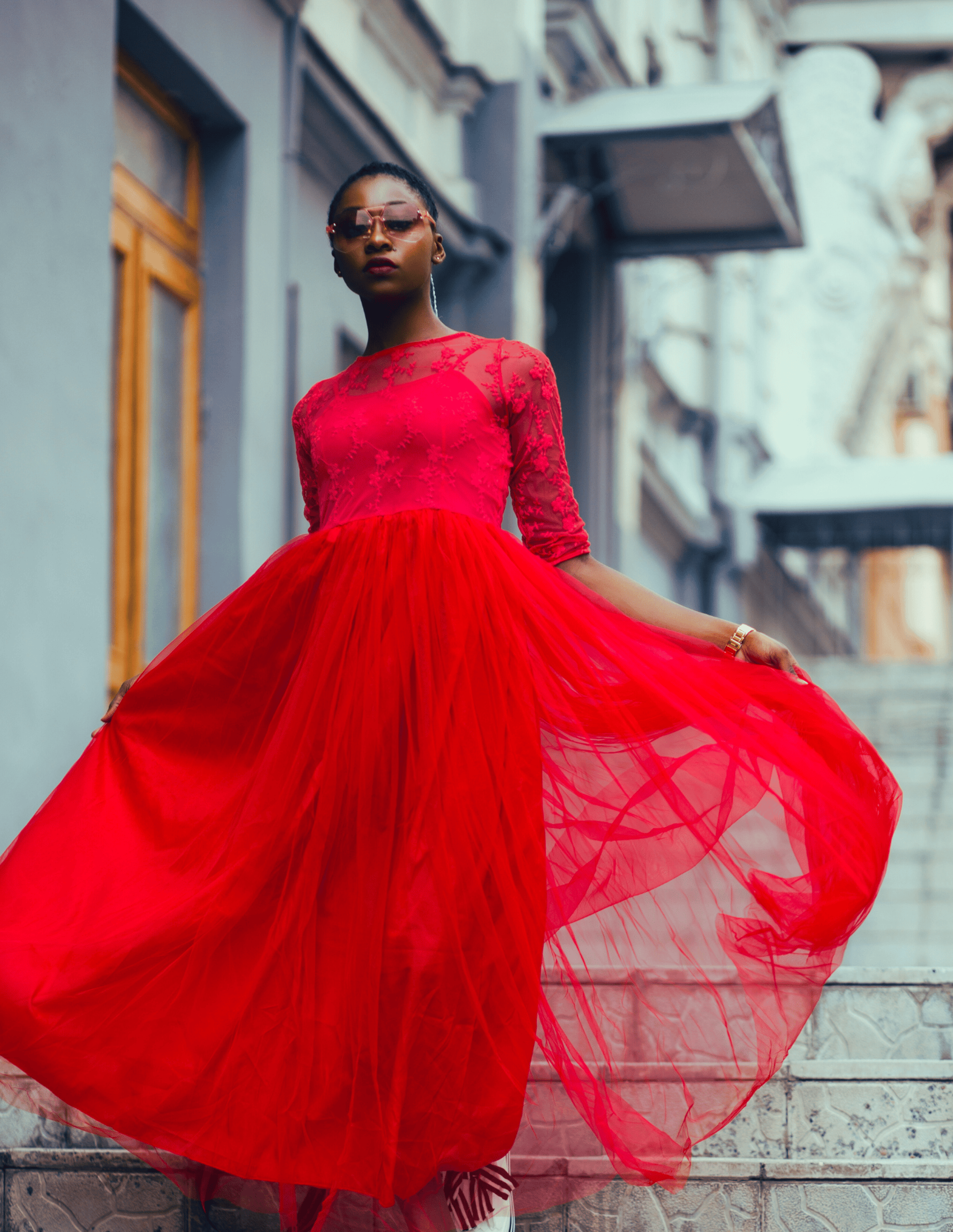 Empowered woman in red flowy dress going down the stairs, symbolizing empowerment, financial freedom as Metal Archetype