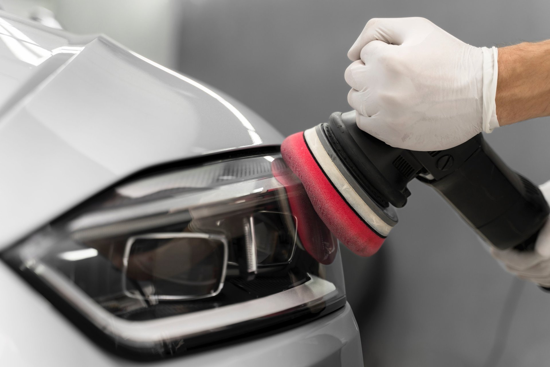 a man with a glove on his hand is changing the tire of a car