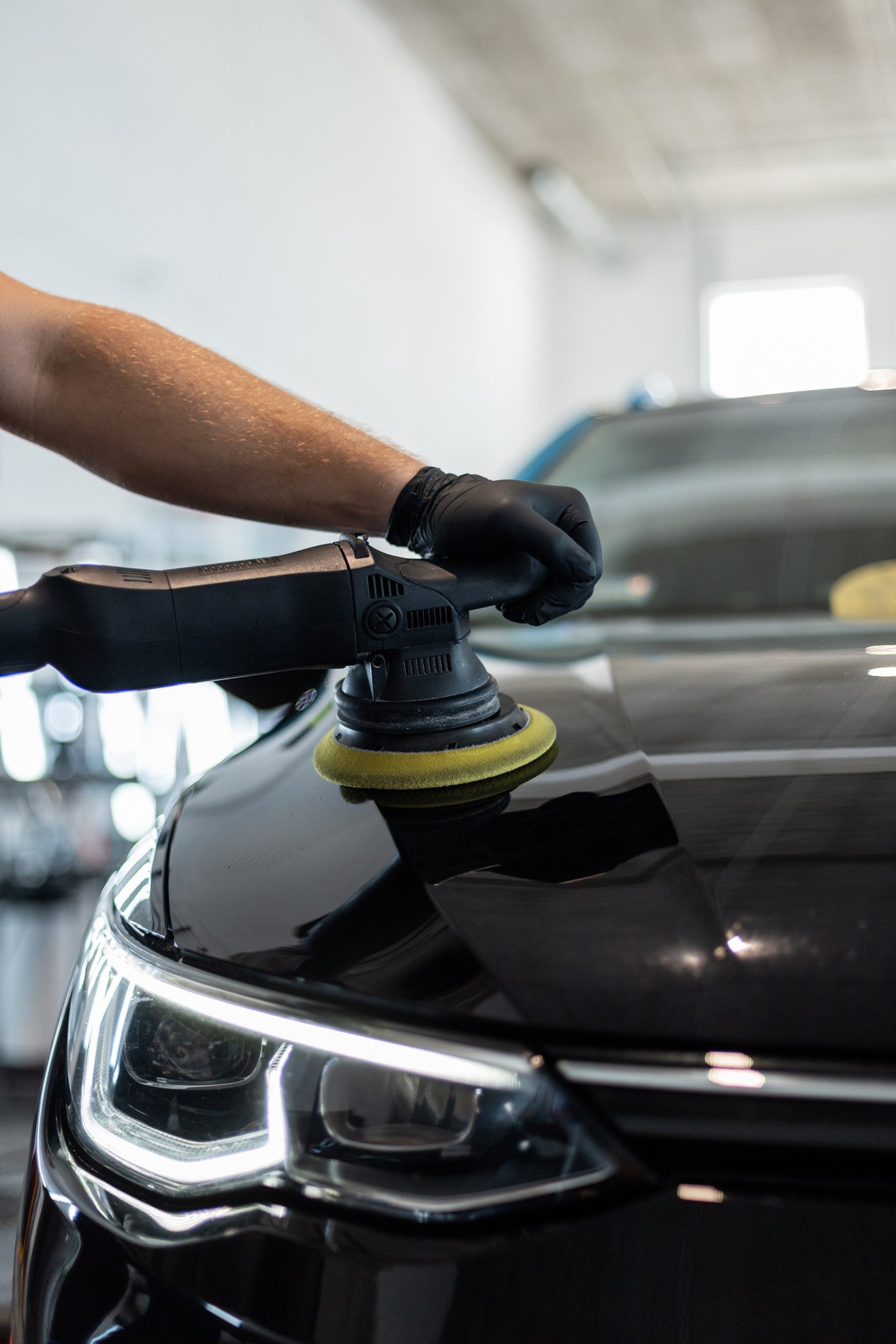 a man with a glove on his hand is changing the tire of a car