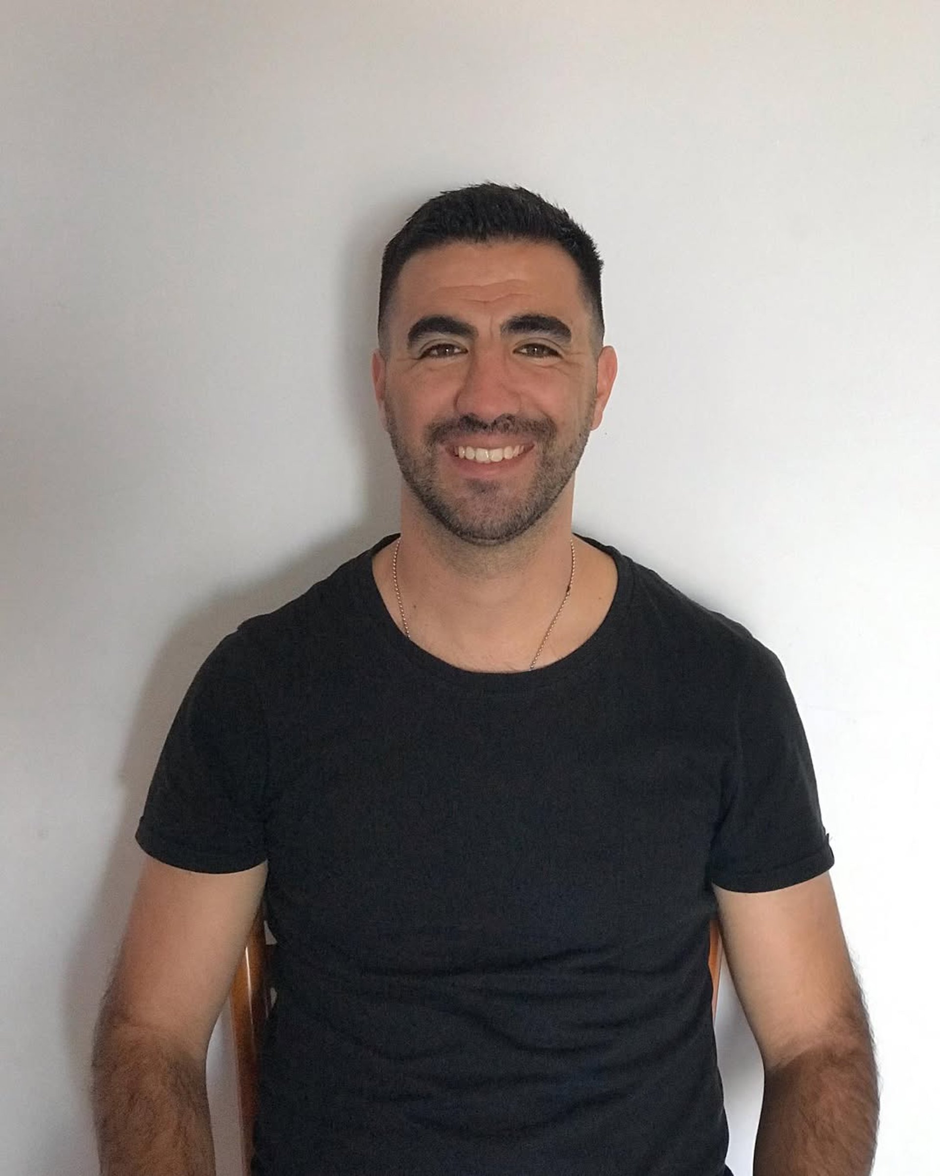 a man in a white shirt and tie posing for a picture