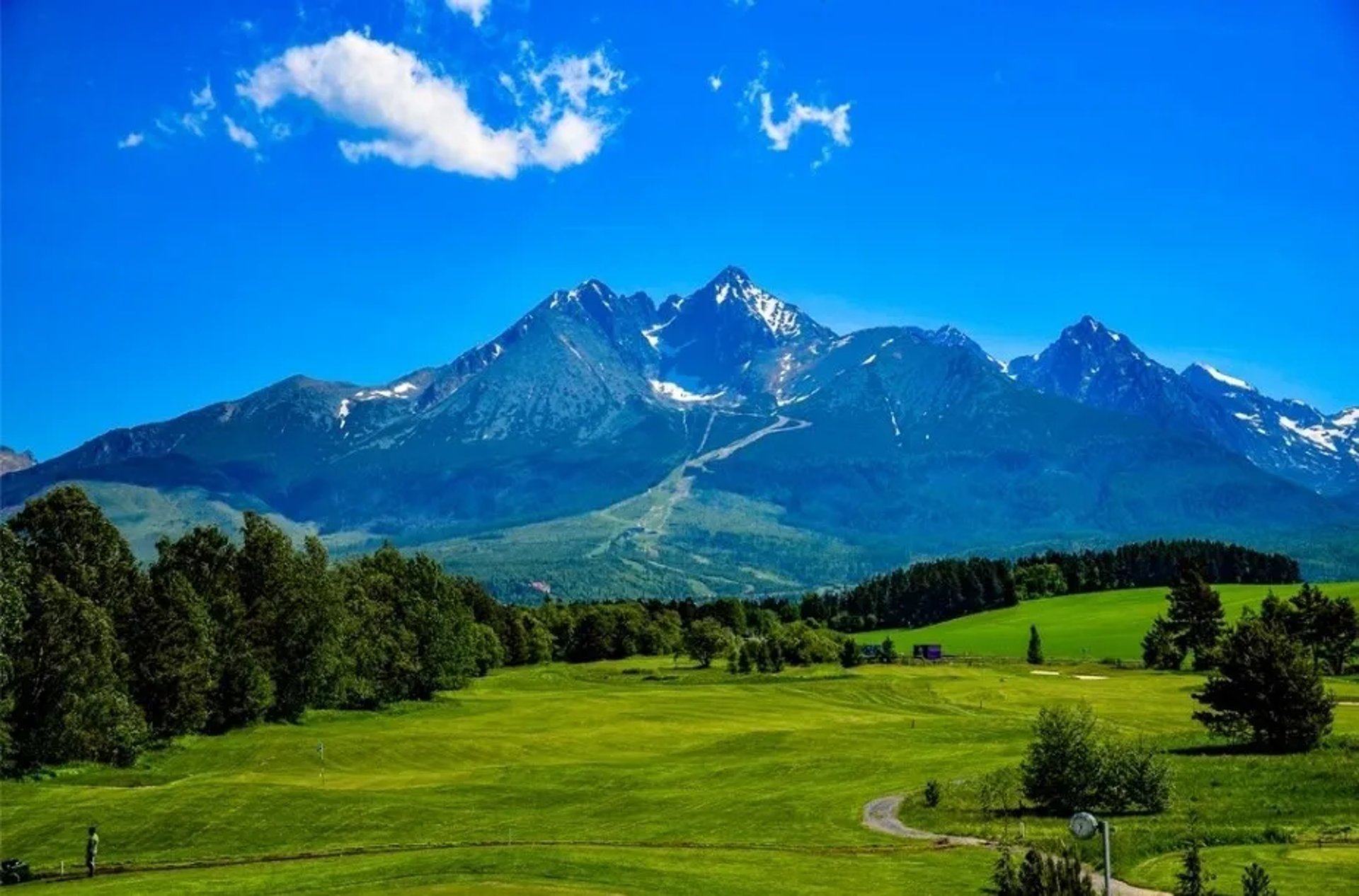 an abstract photo of a curved building with a blue sky in the background