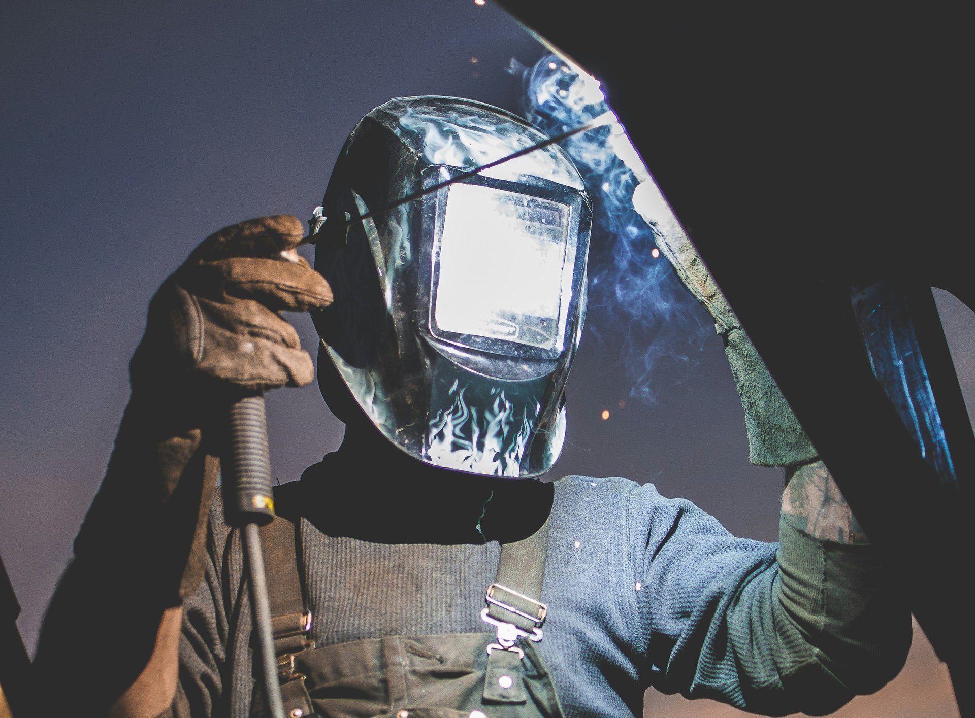 man wearing automatic dark welding helmet