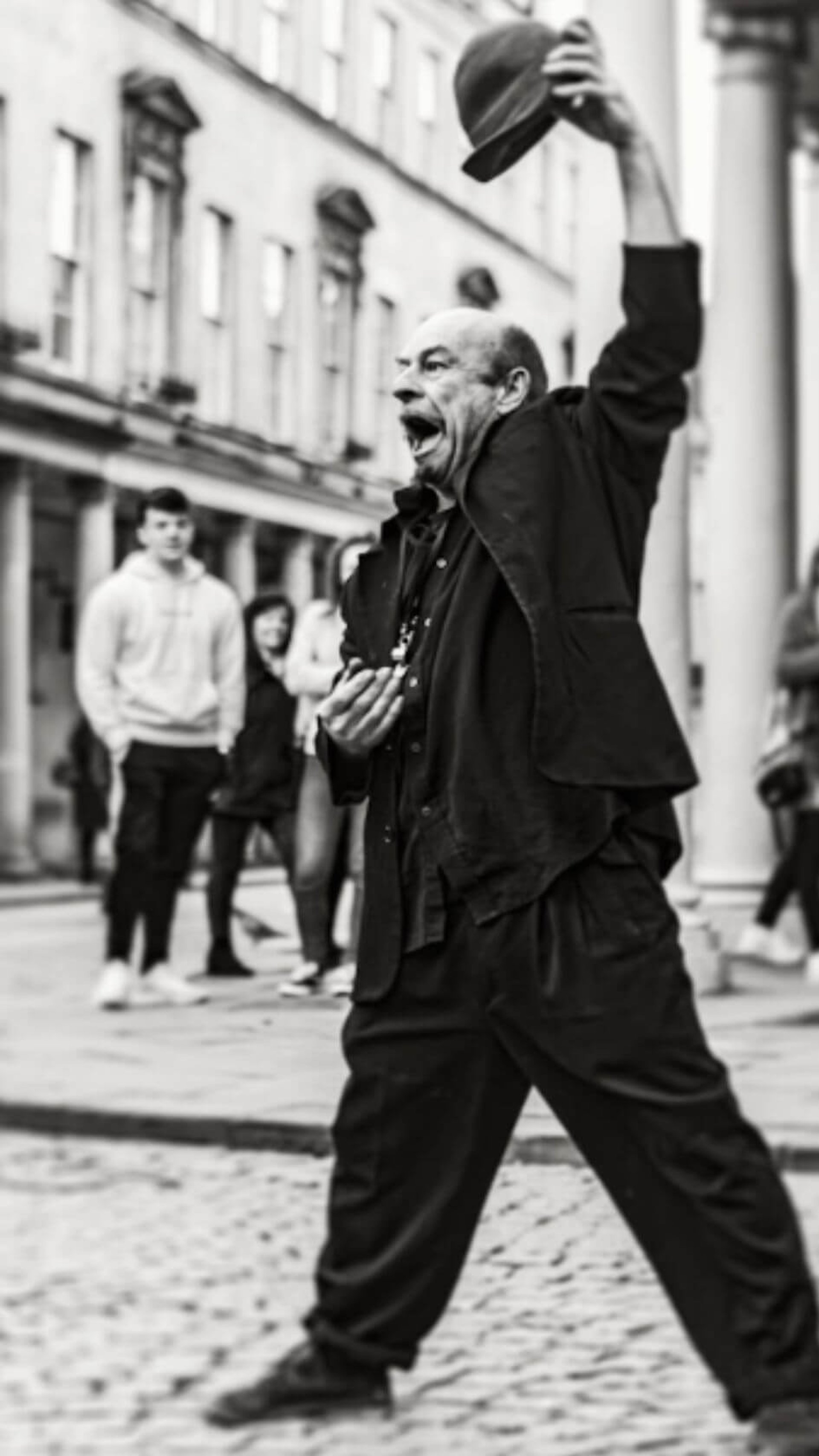 man in black coat walking on street