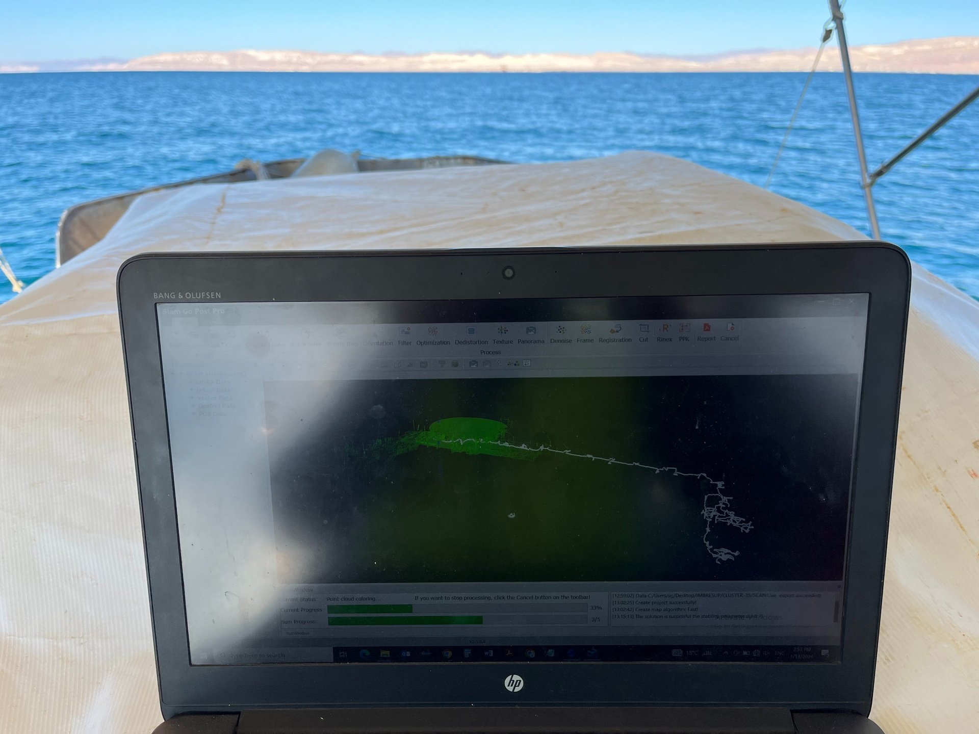 Two construction workers review plans on a tablet.