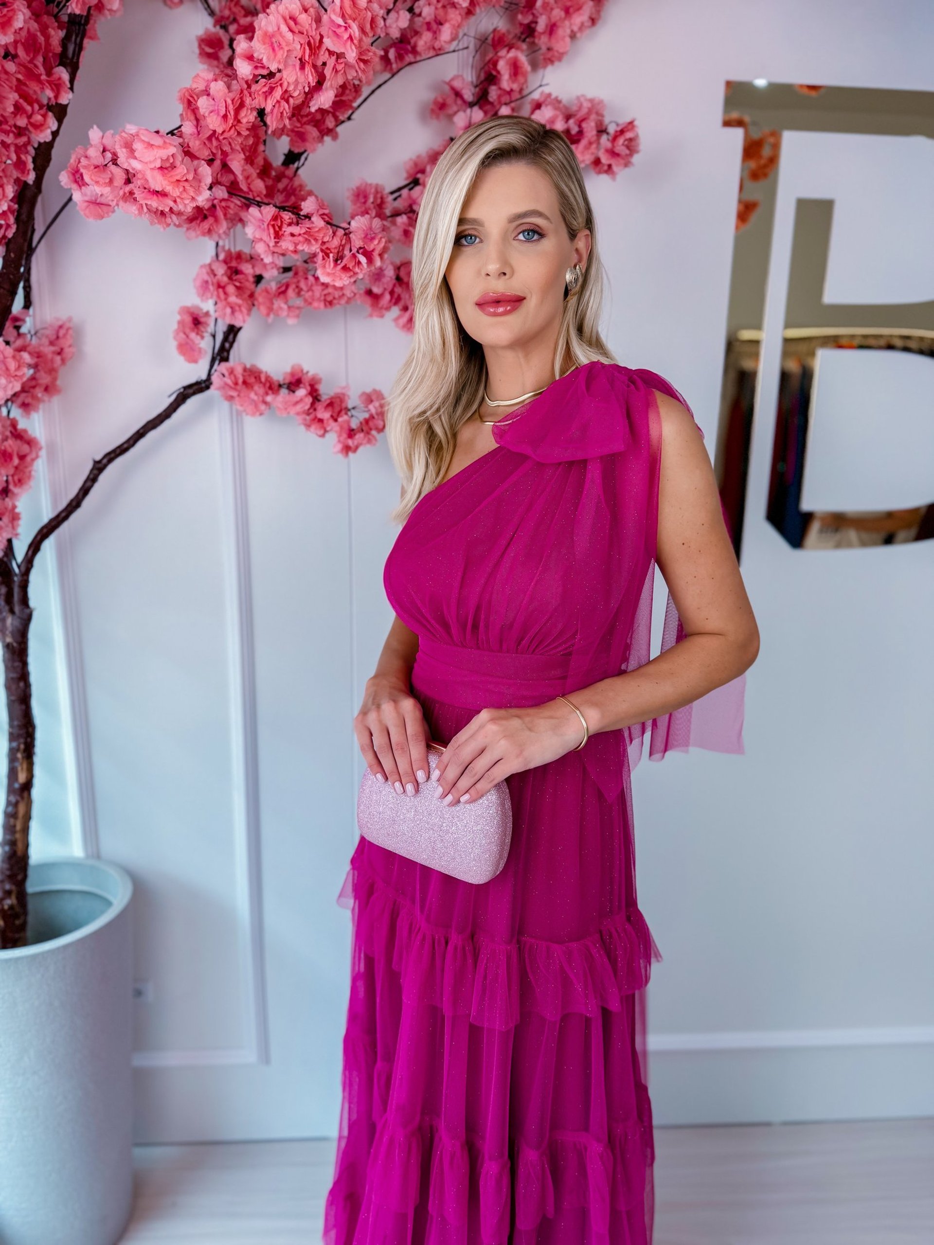 woman holding bouquet standing beside man in black suit