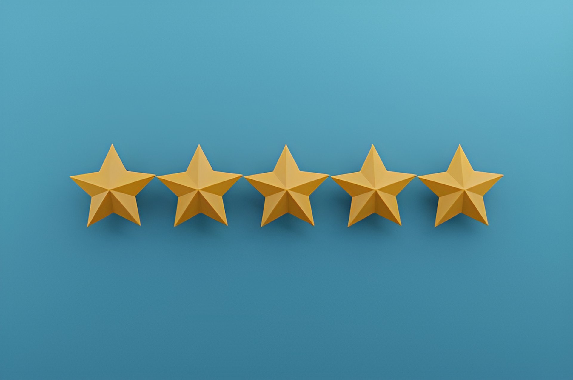 a row of yellow stars sitting on top of a blue and pink surface