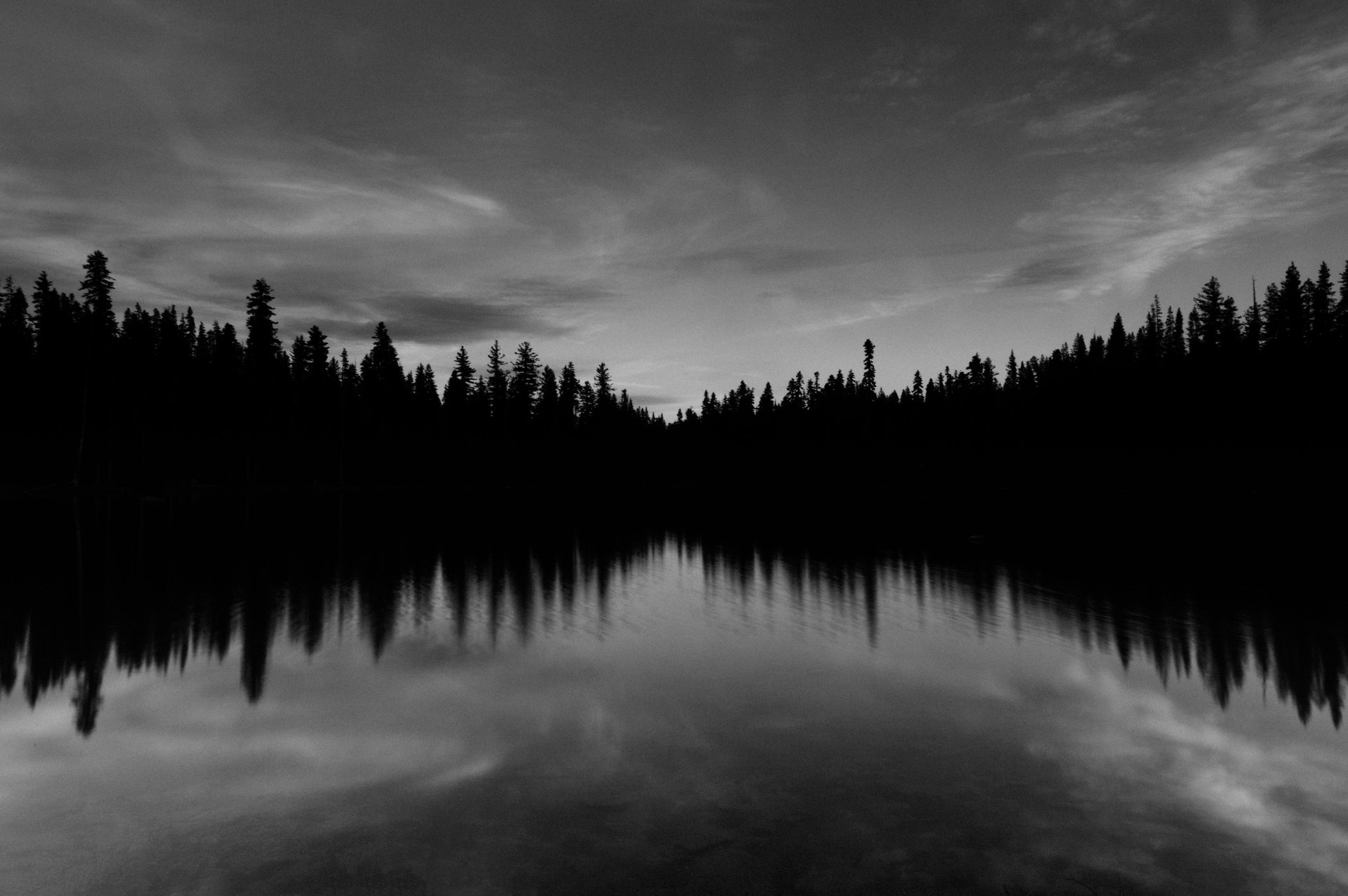 a large body of water under a cloudy sky