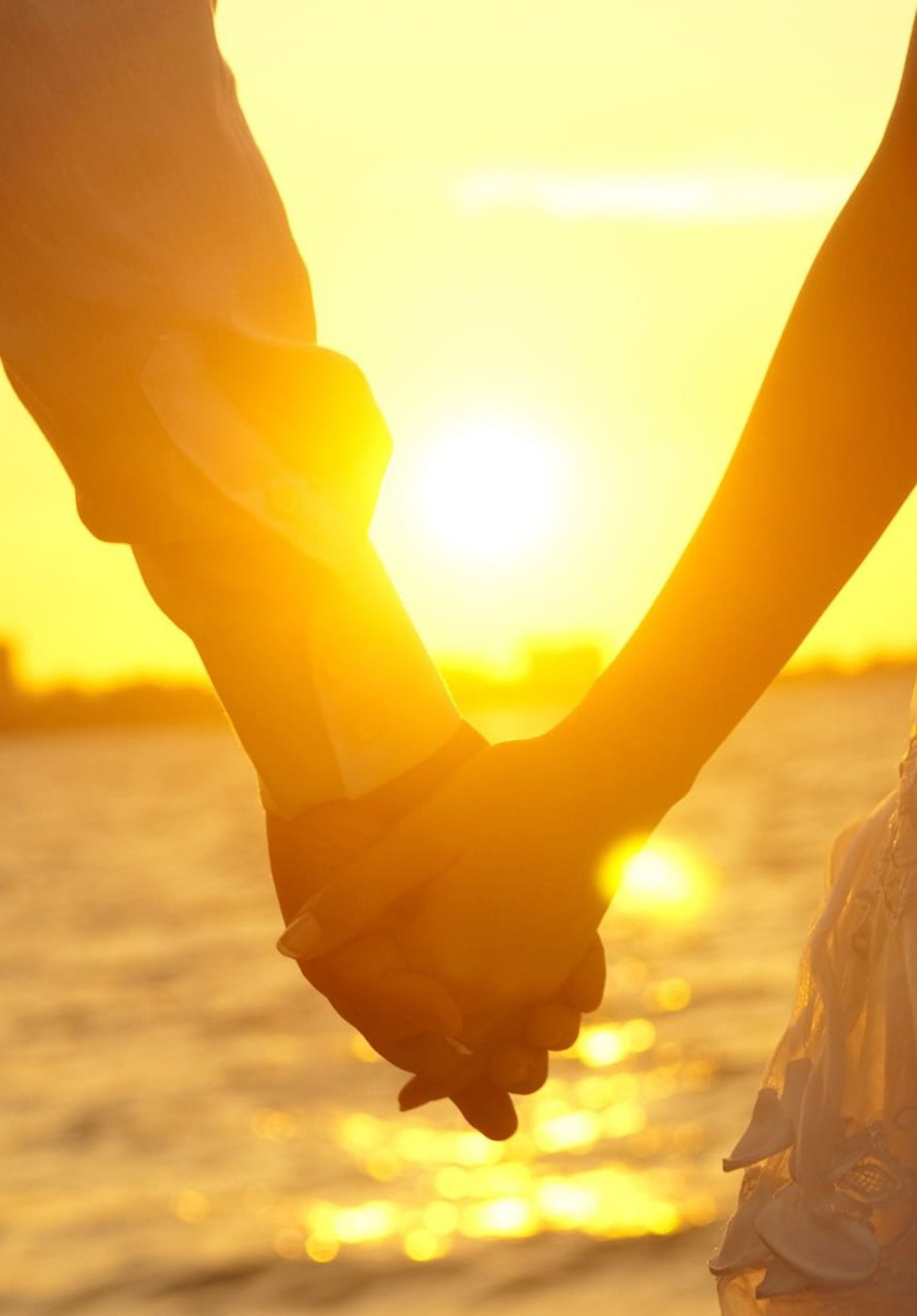 a close up of a person holding the hand of another person