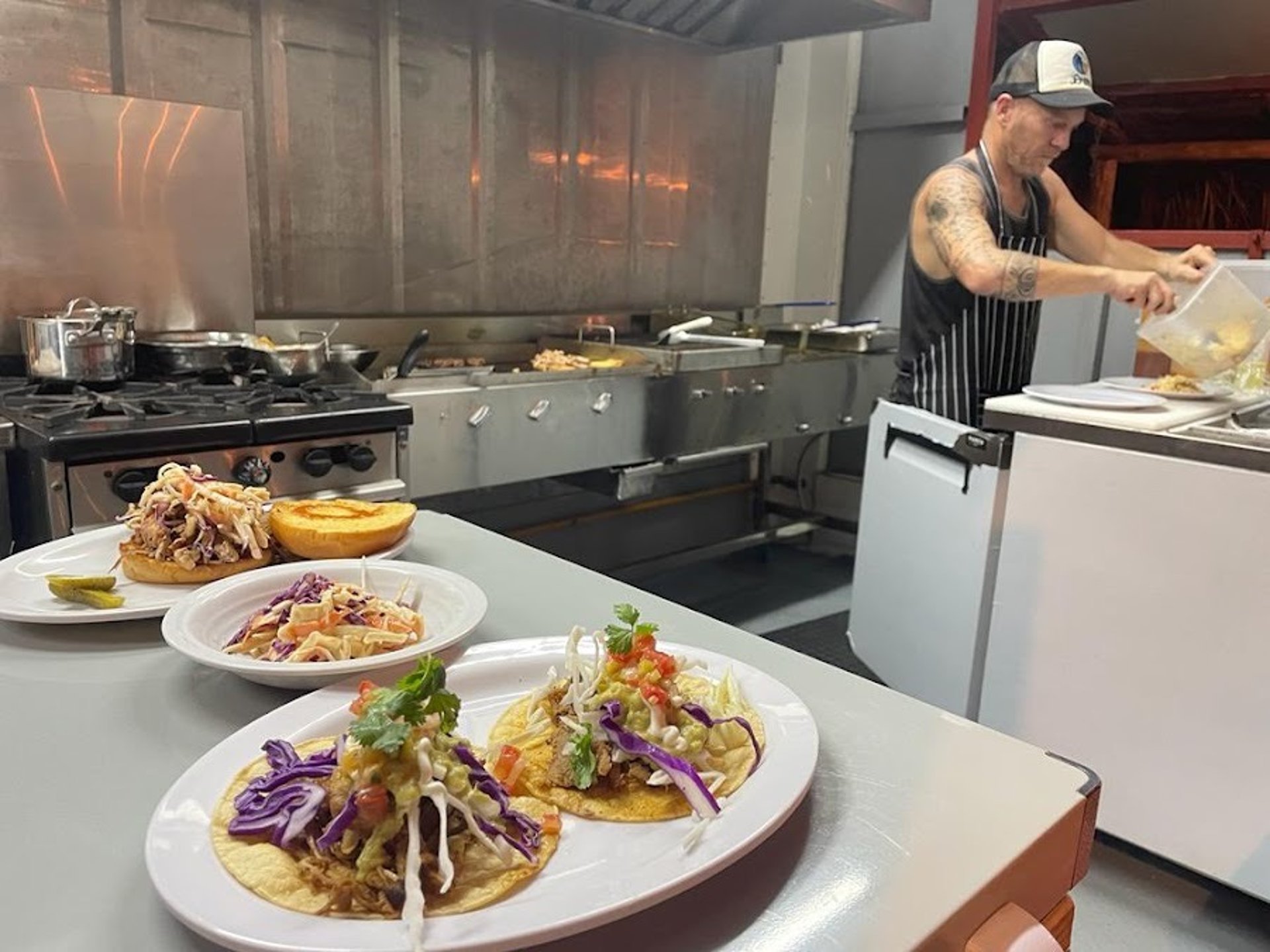 Fresh tacos, pulled pork sandwich and cole slaw. Barrel Bar & Grill restaurant kitchen.