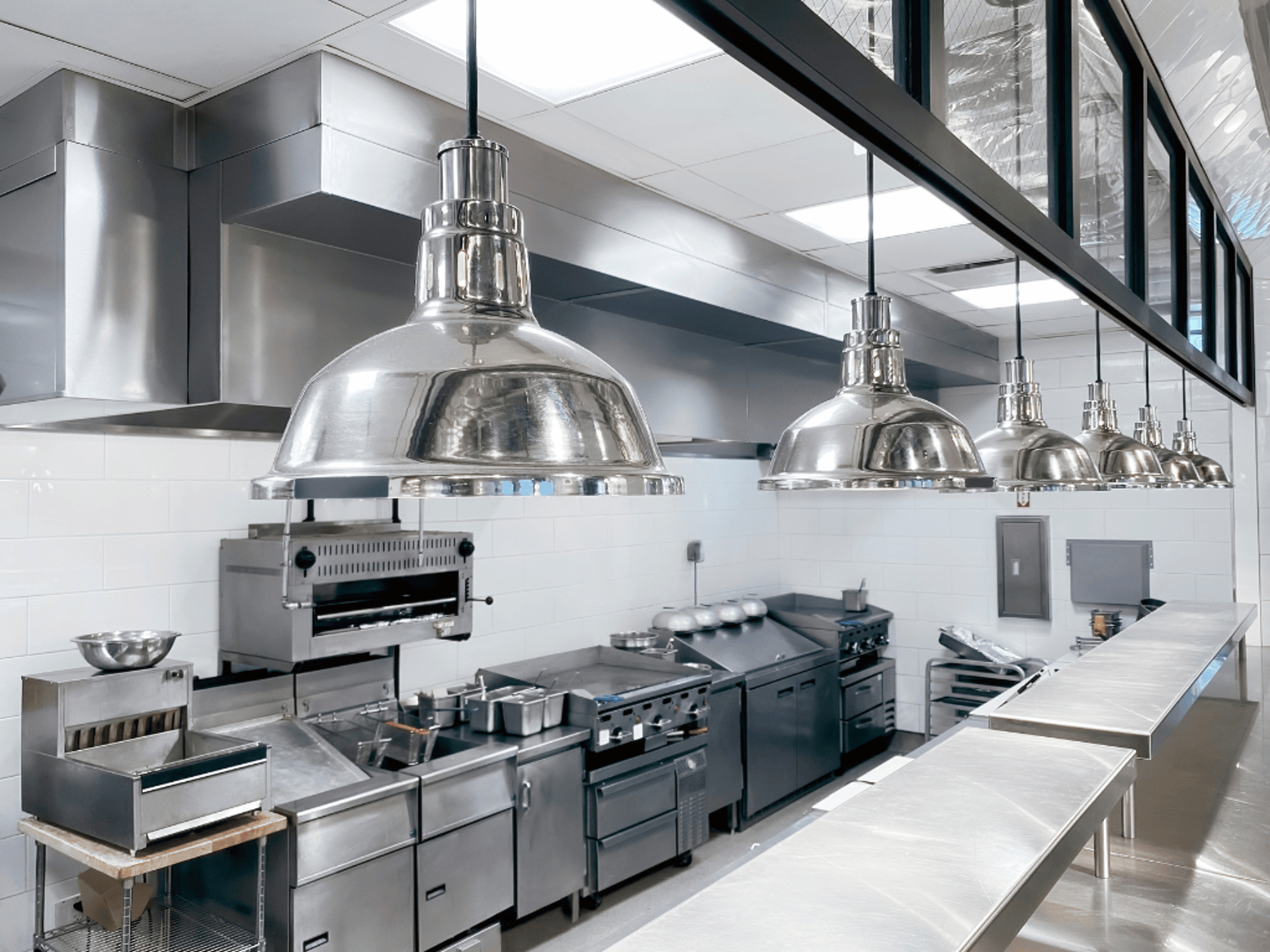 Kitchen utensils hang in a professional kitchen.
