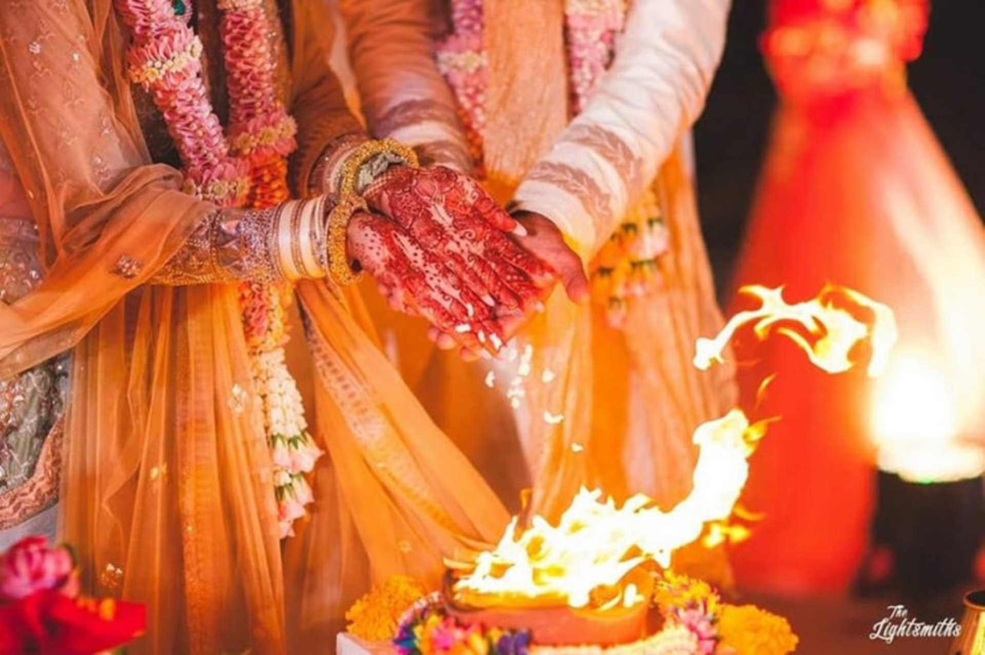 a group of people standing around a stage with candles