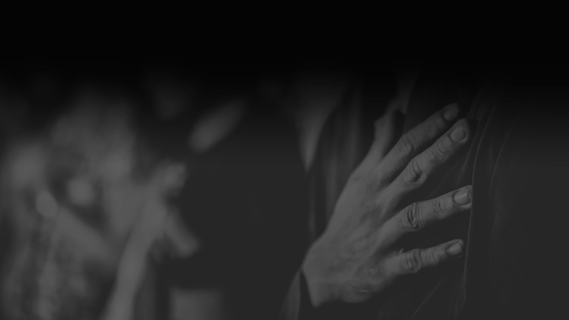 A group of people standing in a circle with their hands together