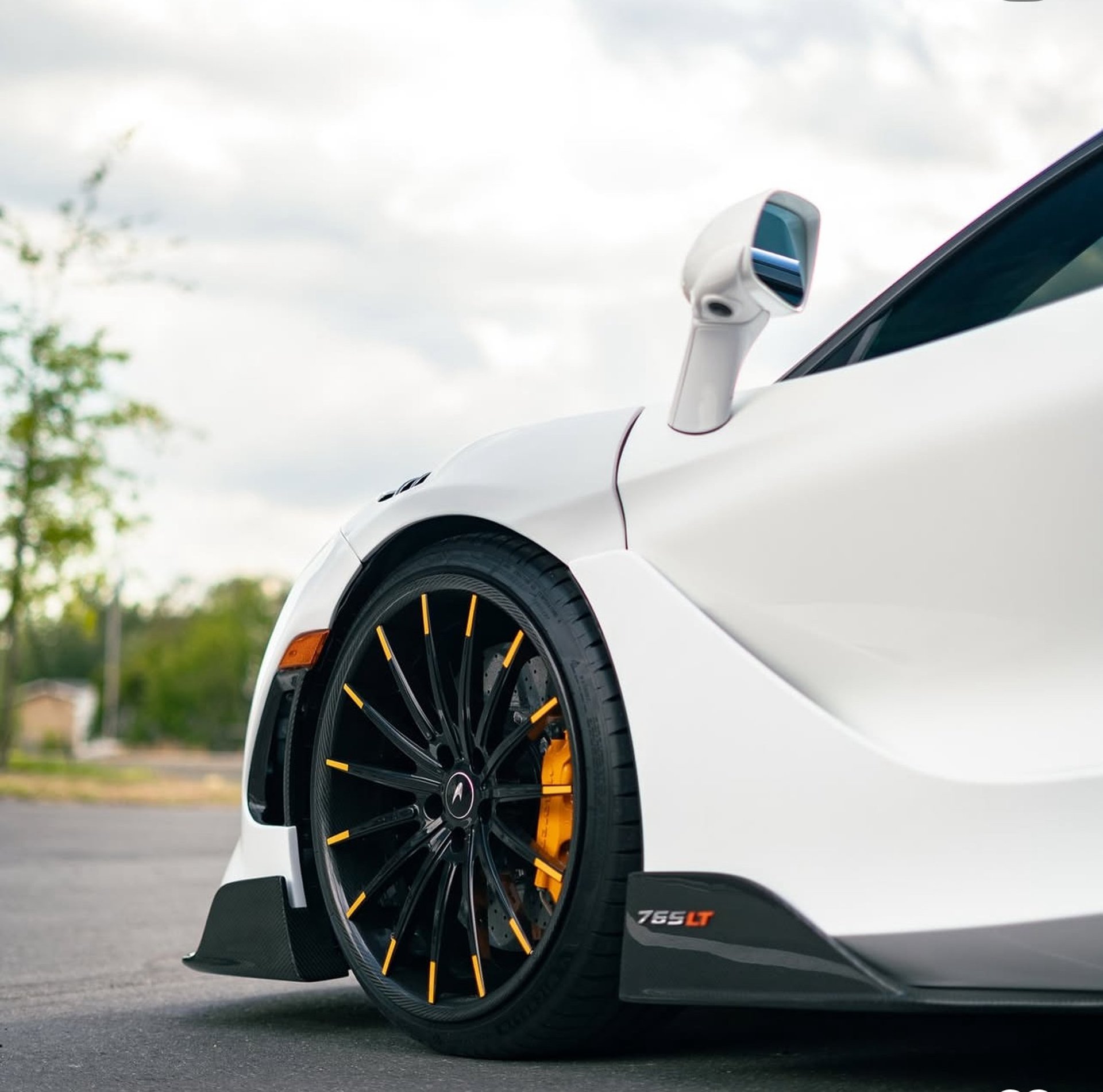 a white sports car parked in front of a building