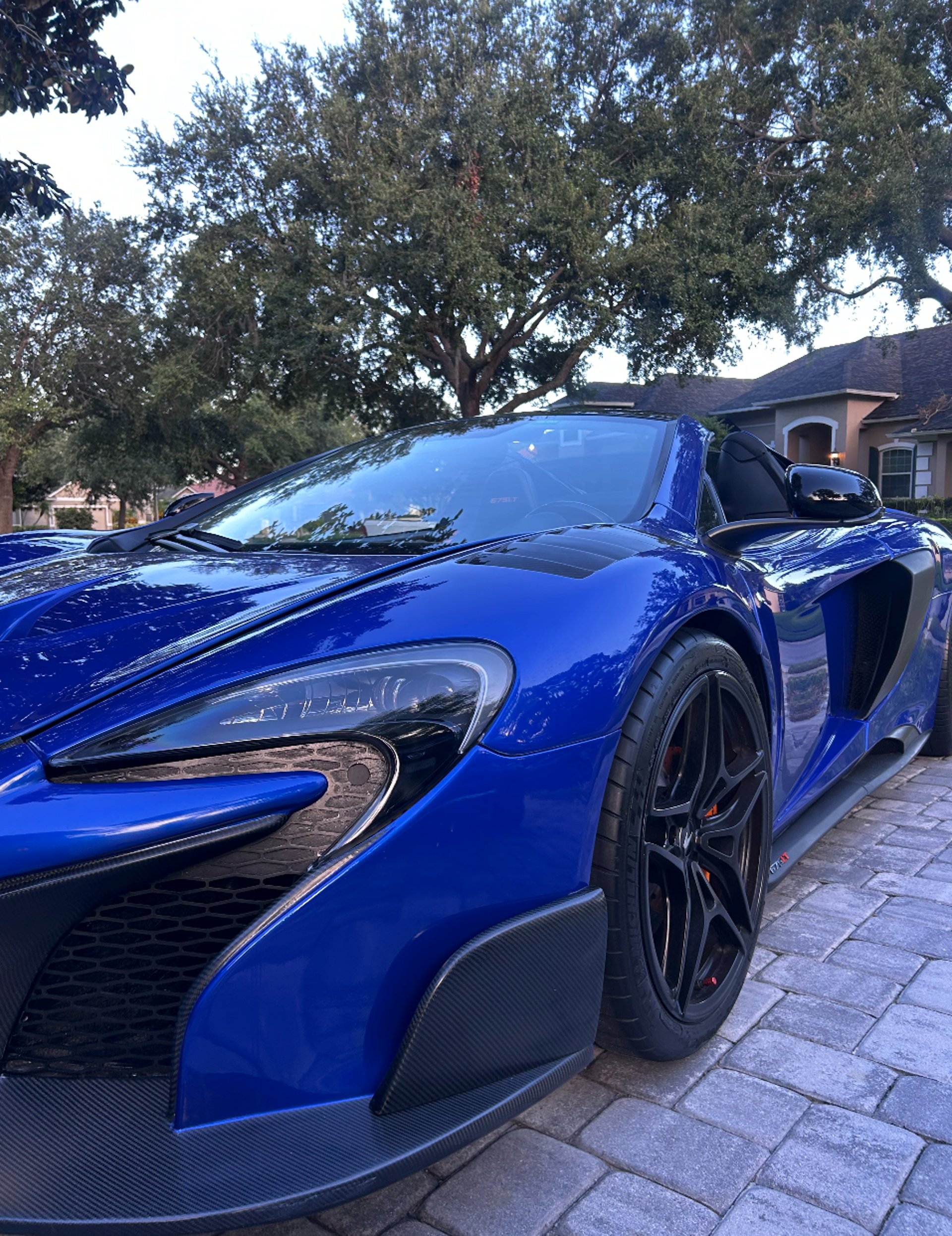 a blue sports car parked in a garage