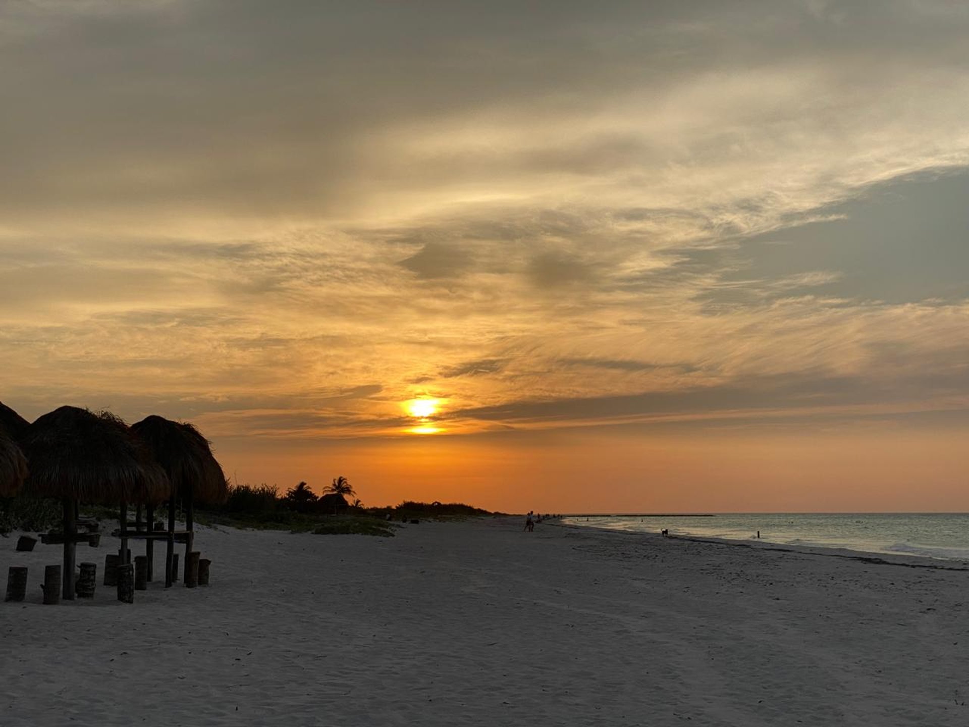 woman wearing yellow long-sleeved dress under white clouds and blue sky during daytime
