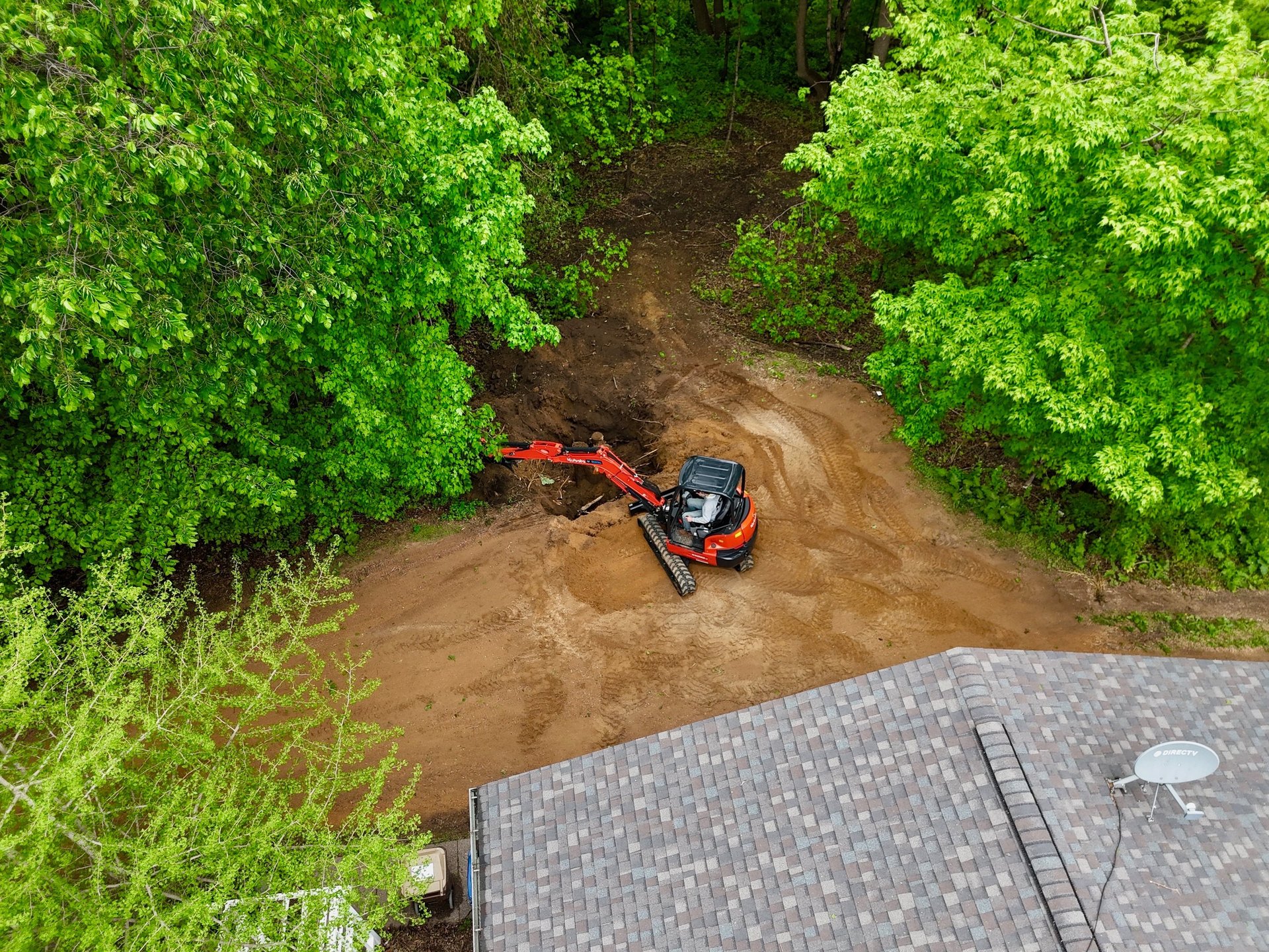 Kubota excavator digging dirt in central mn
