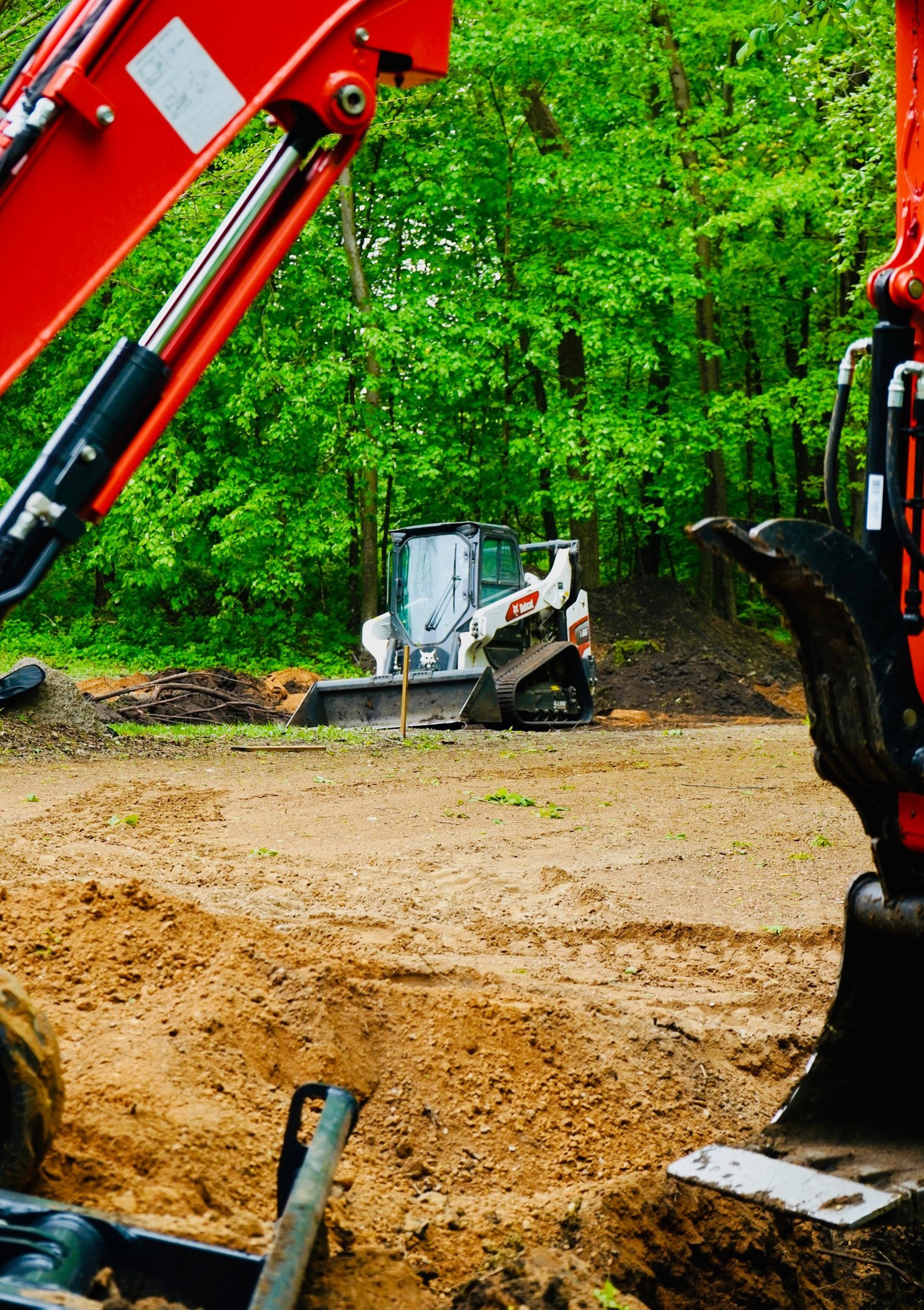 bobcat skid steer grading gravel lot in central mn