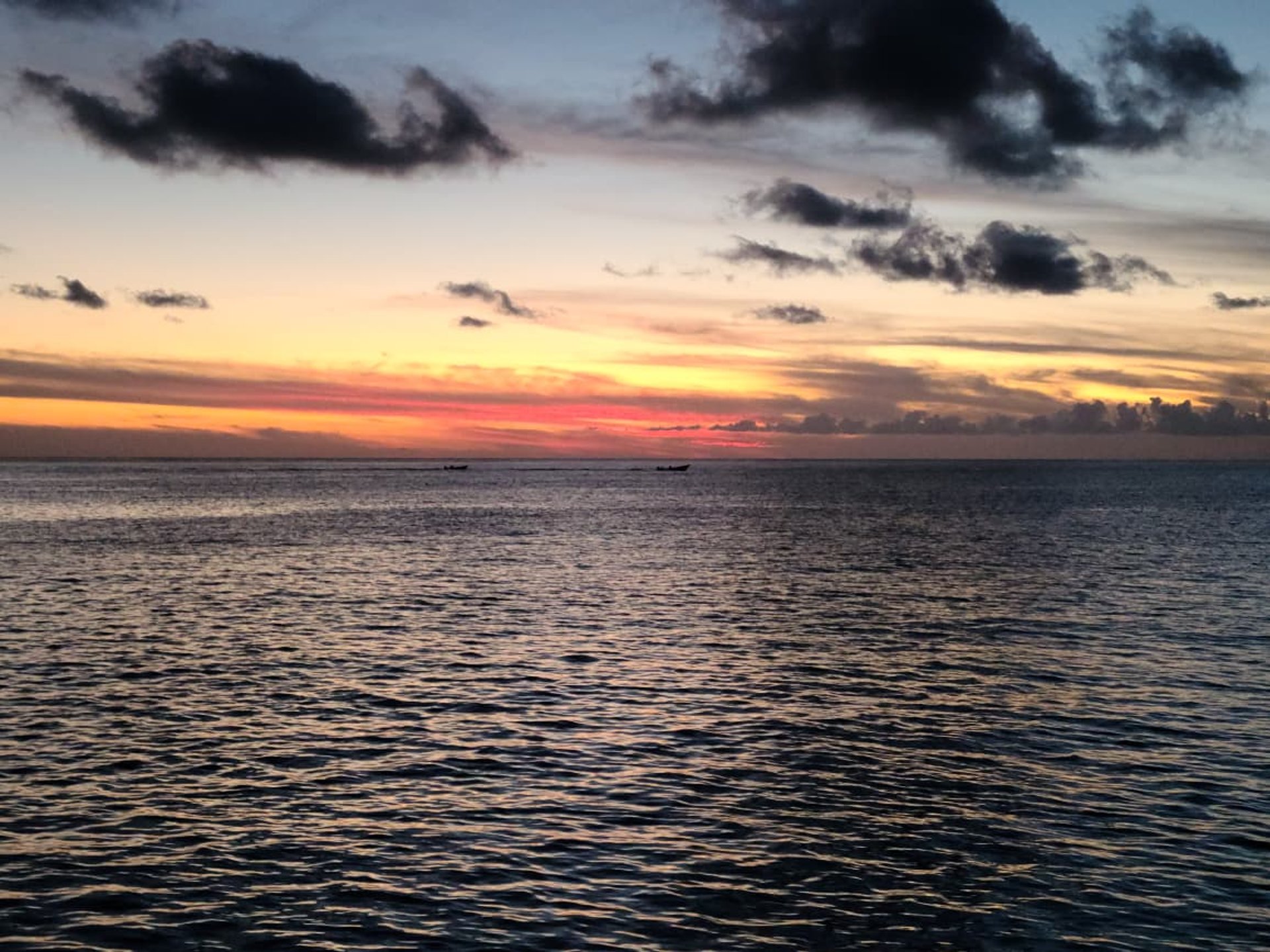 a small stand on a beach with chairs and a table