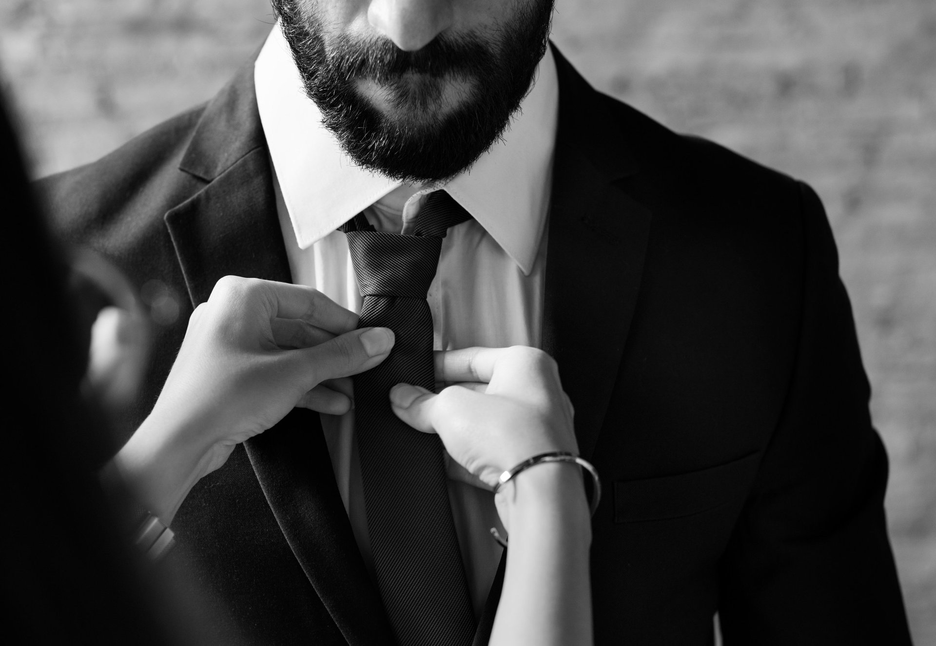 a black and white photo of a man covering his eyes