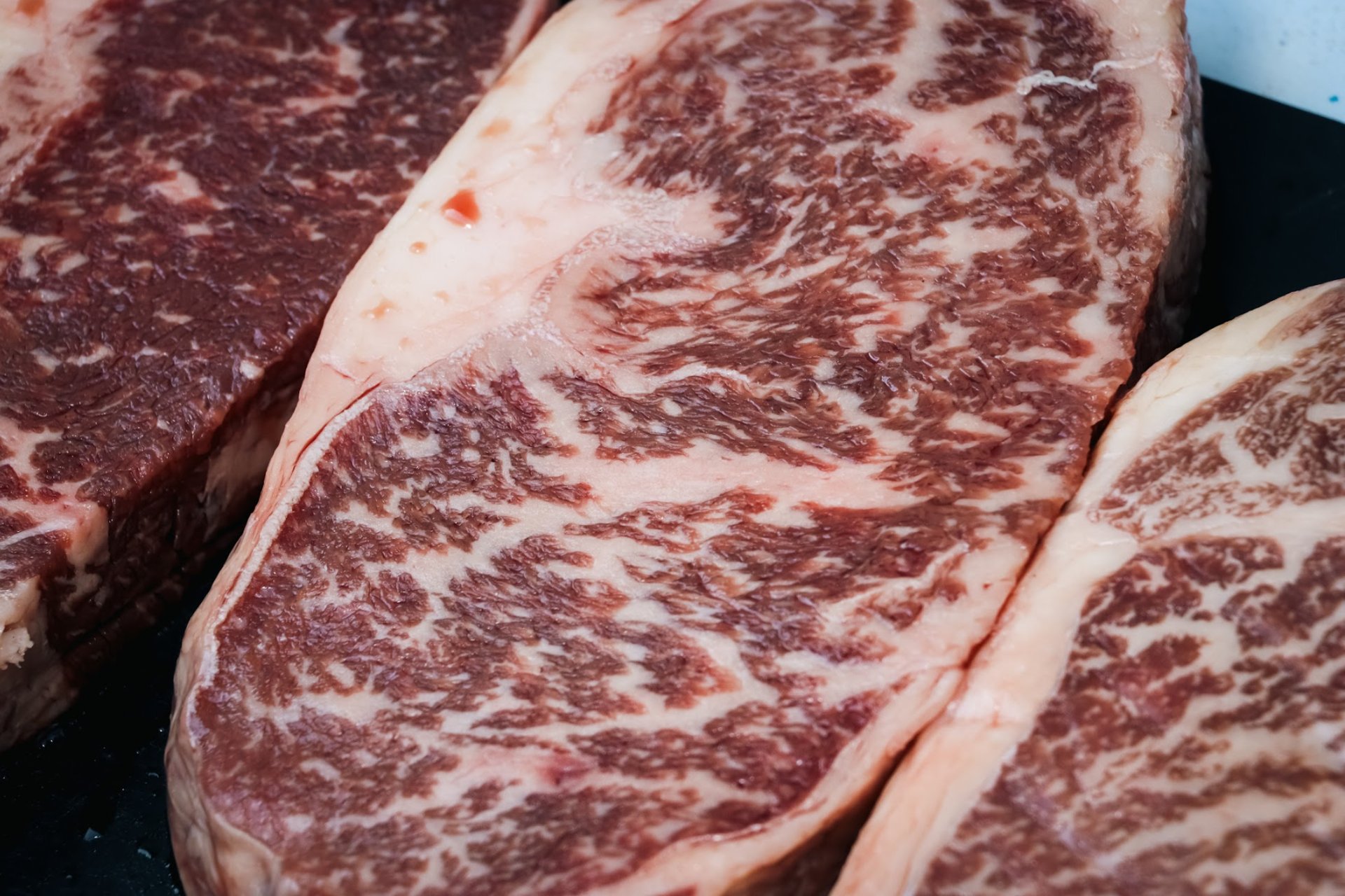 an abstract photo of a curved building with a blue sky in the background