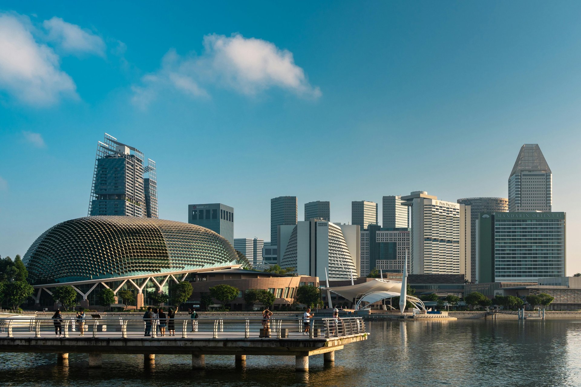 an abstract photo of a curved building with a blue sky in the background