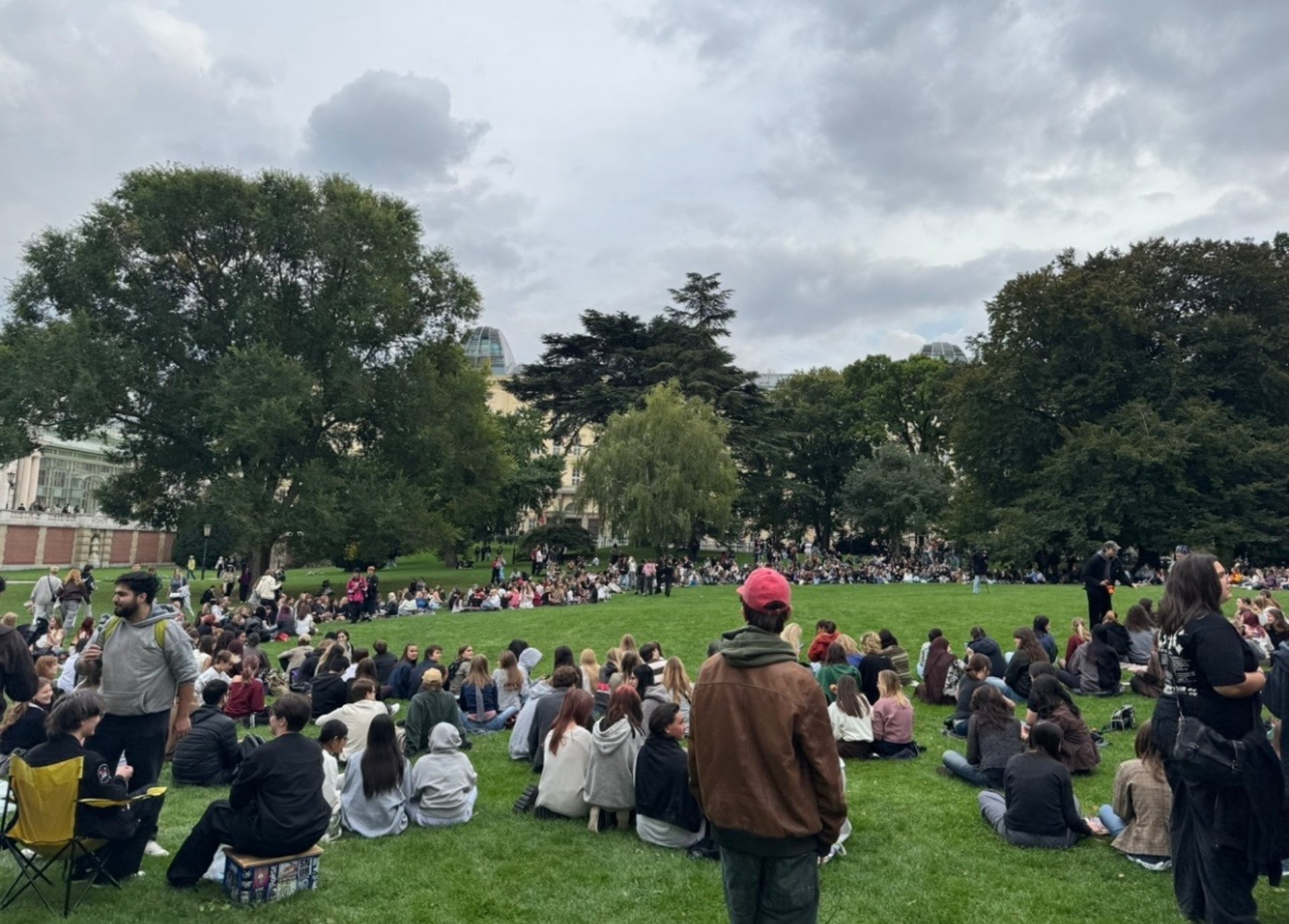 two person shaking hands near white painted wall