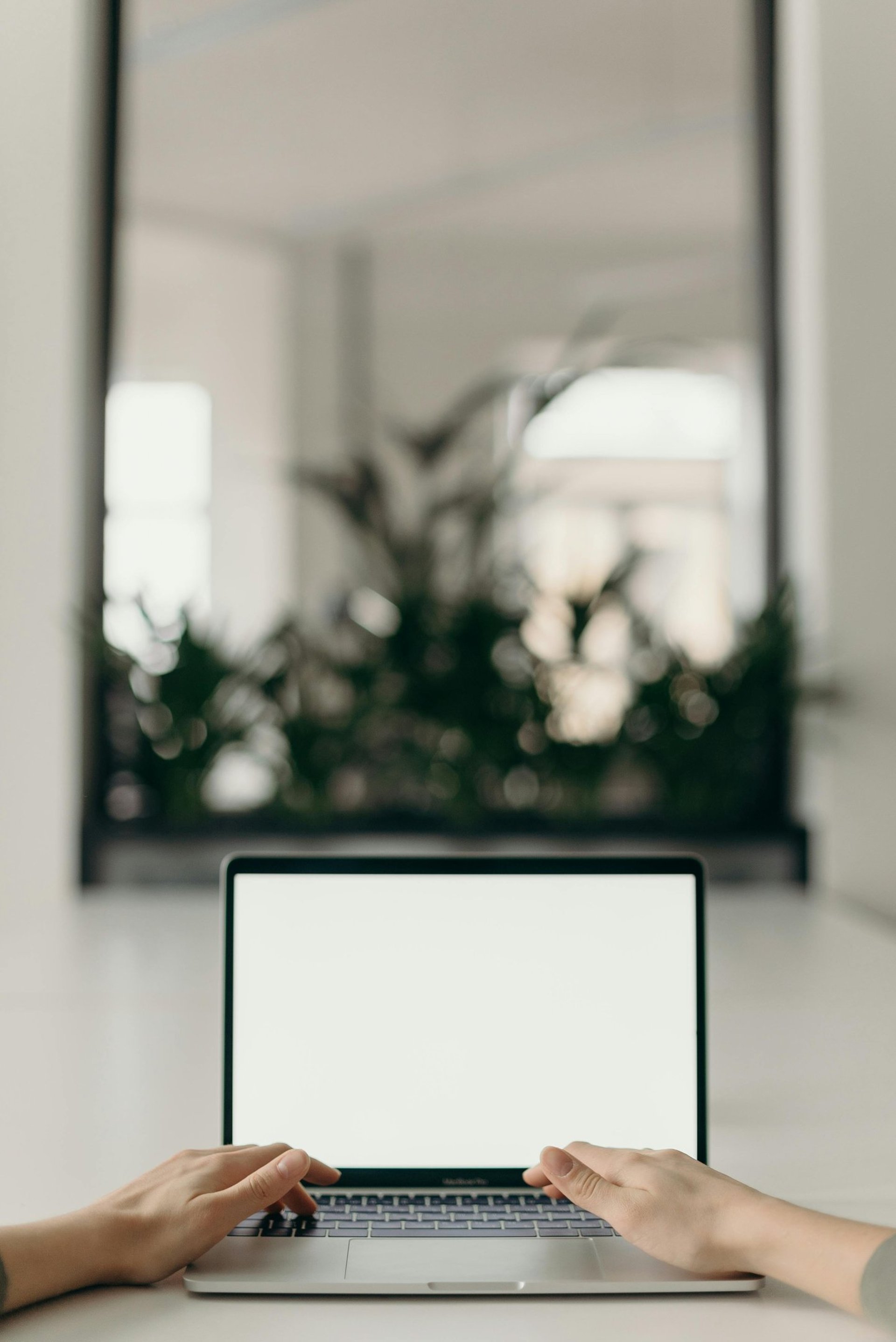 a woman is typing on her laptop outside